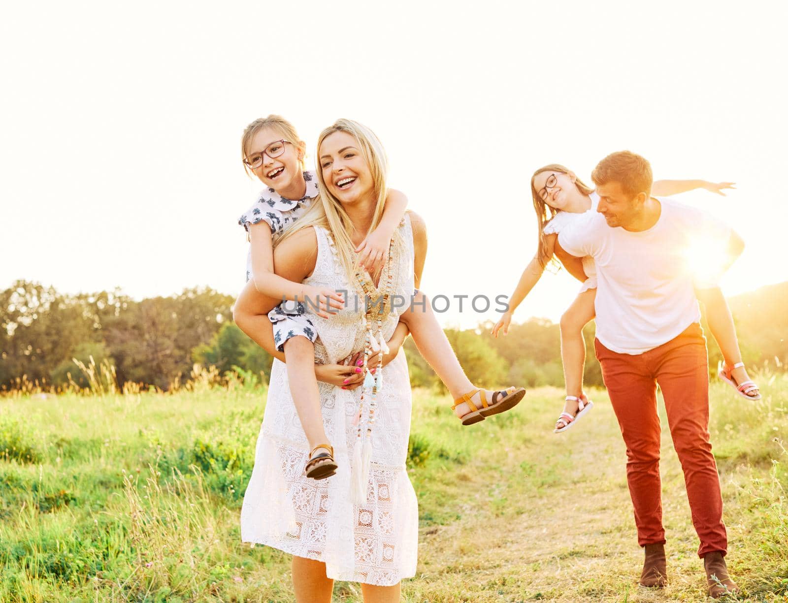 child family outdoor mother woman father girl happy happiness lifestyle having fun bonding piggyback by Picsfive