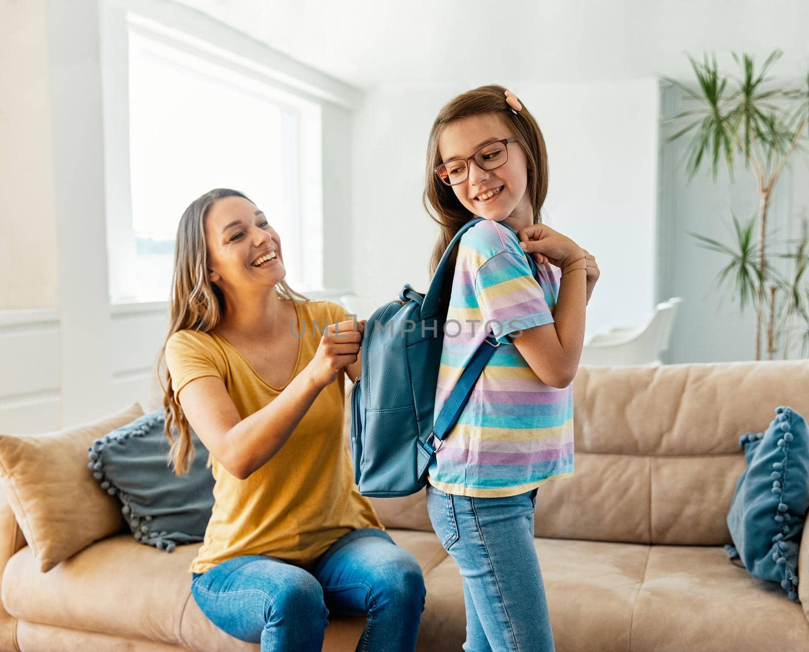 child mother family education school girl home daughter backpack help parent getting ready elementary teen morning hug love helping together by Picsfive