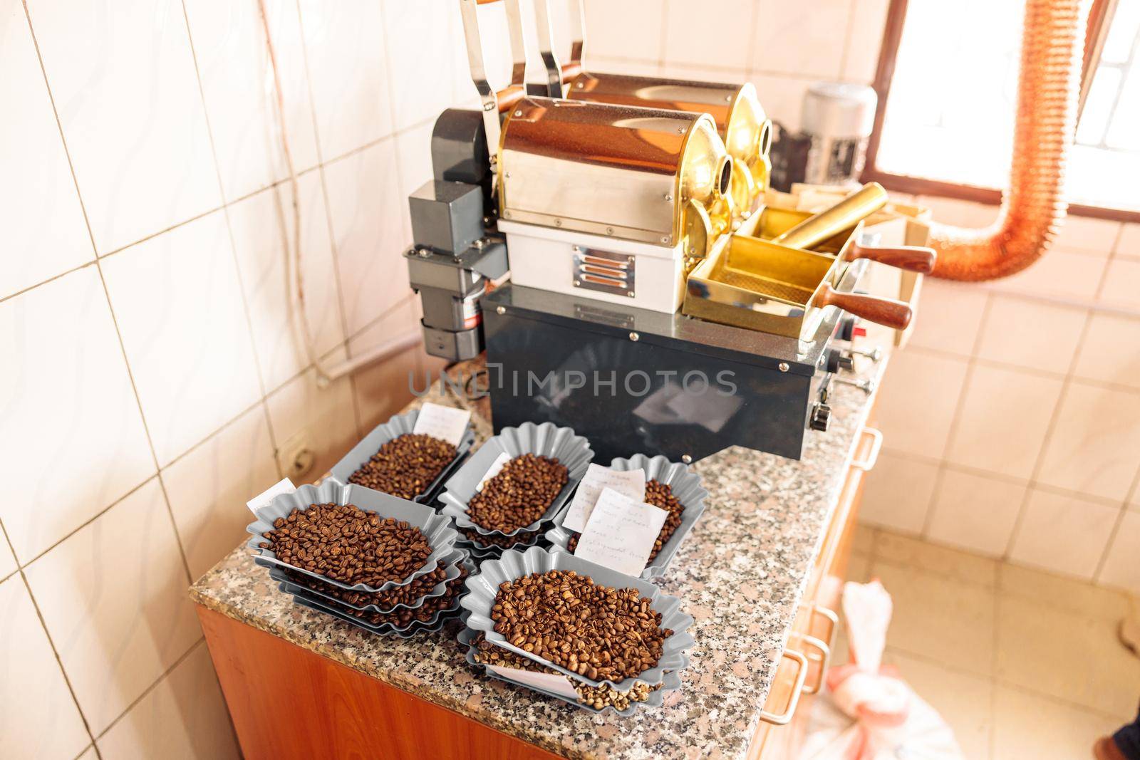 Top view of coffee machine and bowls with roasted coffee beans