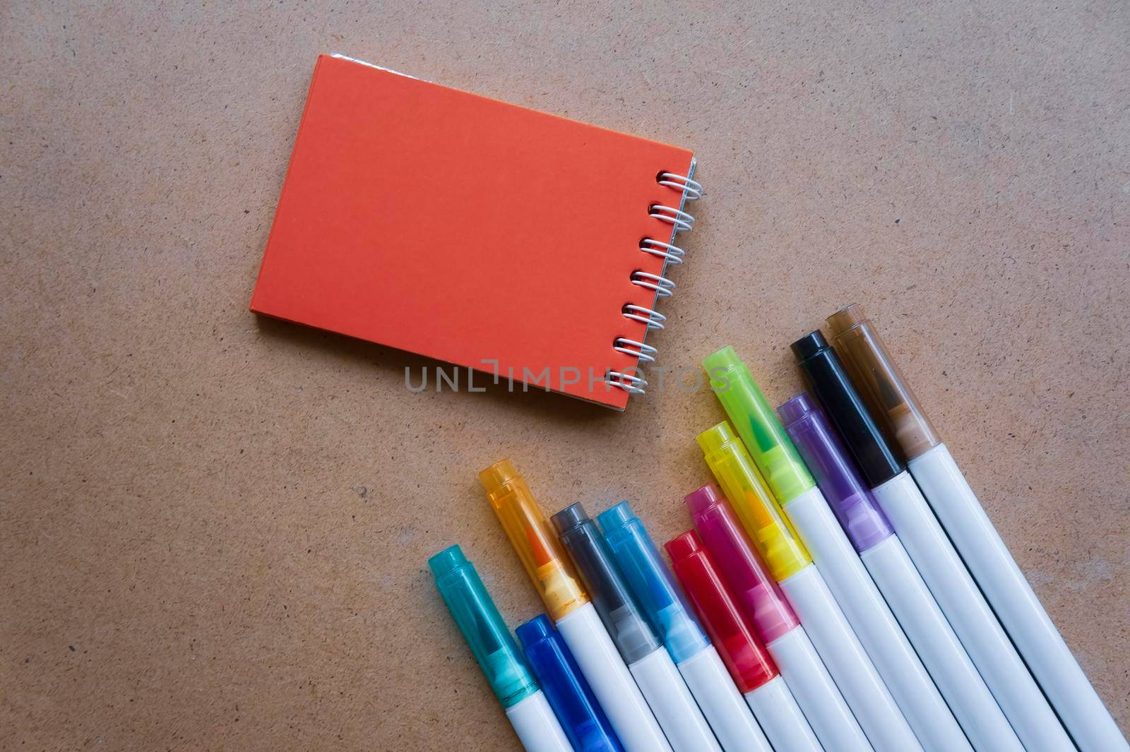 Back to school. The red pages of the notebook. Holiday notes. Colorful markers for children's art. empty paper for painting, space, template. Education School concept. Kraft backgrounds.