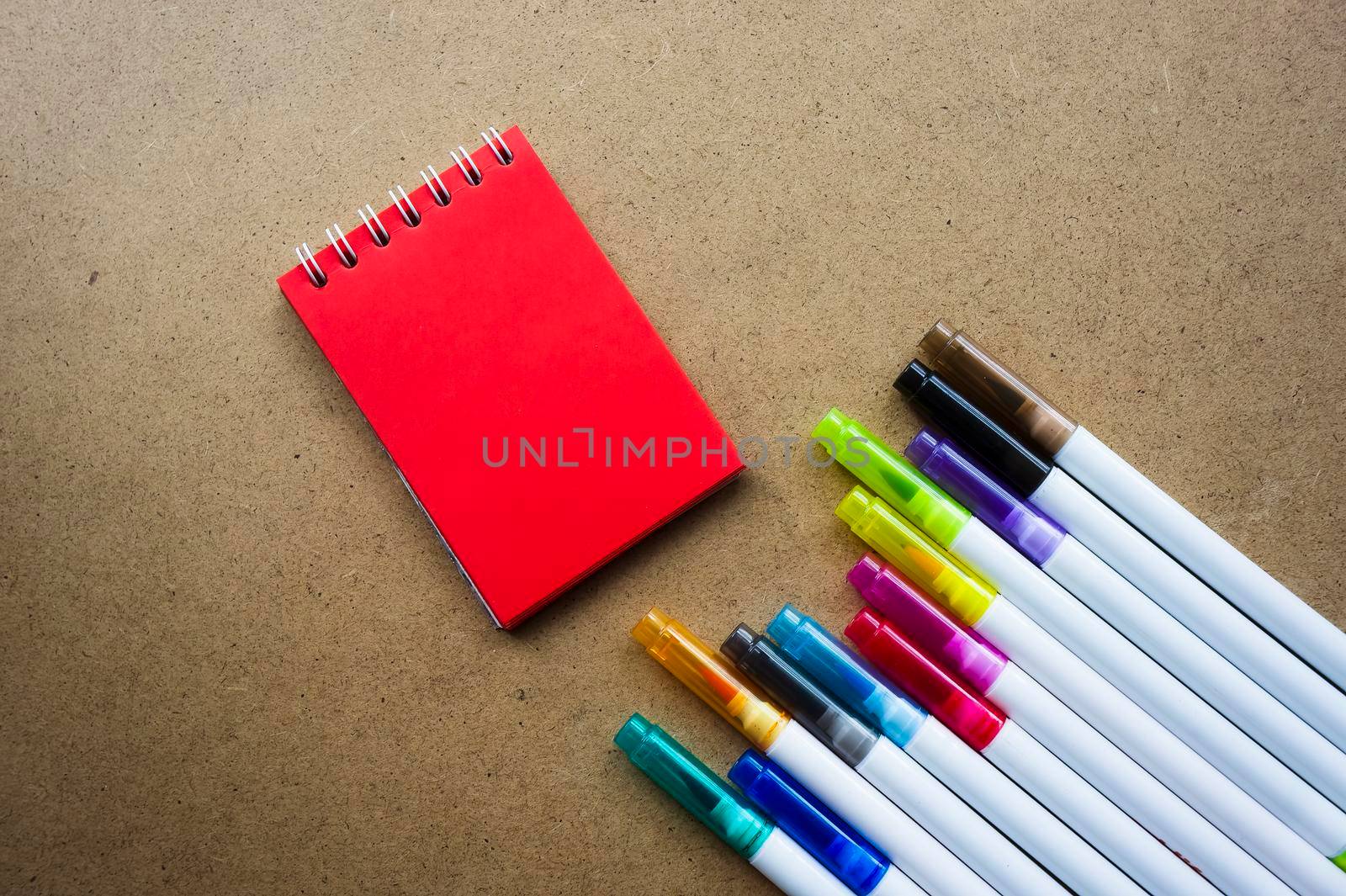 Back to school. The red pages of the notebook. Holiday notes. Colorful markers for children's art. empty paper for painting, space, template. Education School concept. Kraft backgrounds.