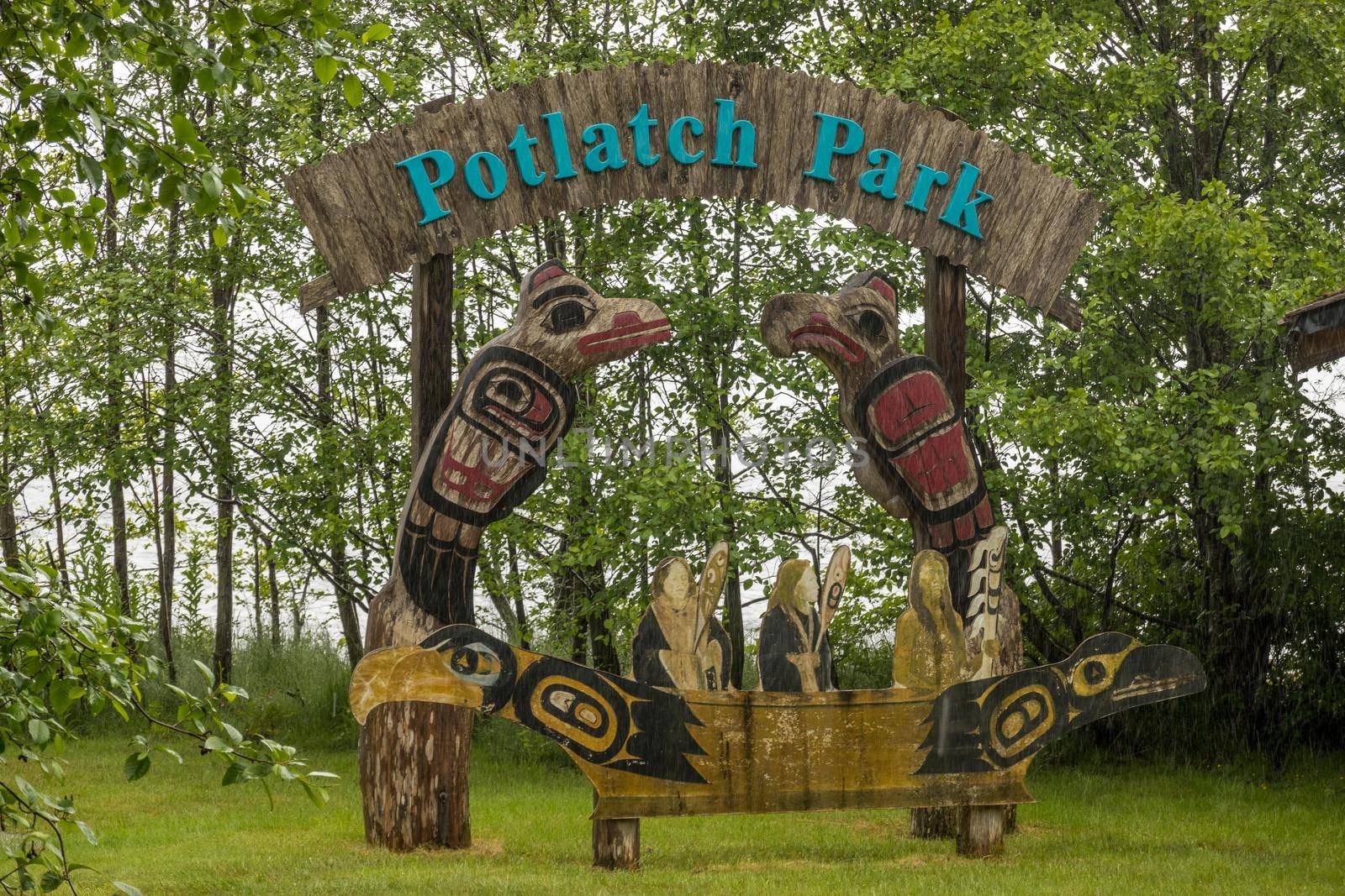 Ketchikan, AK - 10 June 2022: Totem poles and welcome sign in Potlatch Park in Ketchikan Alaska