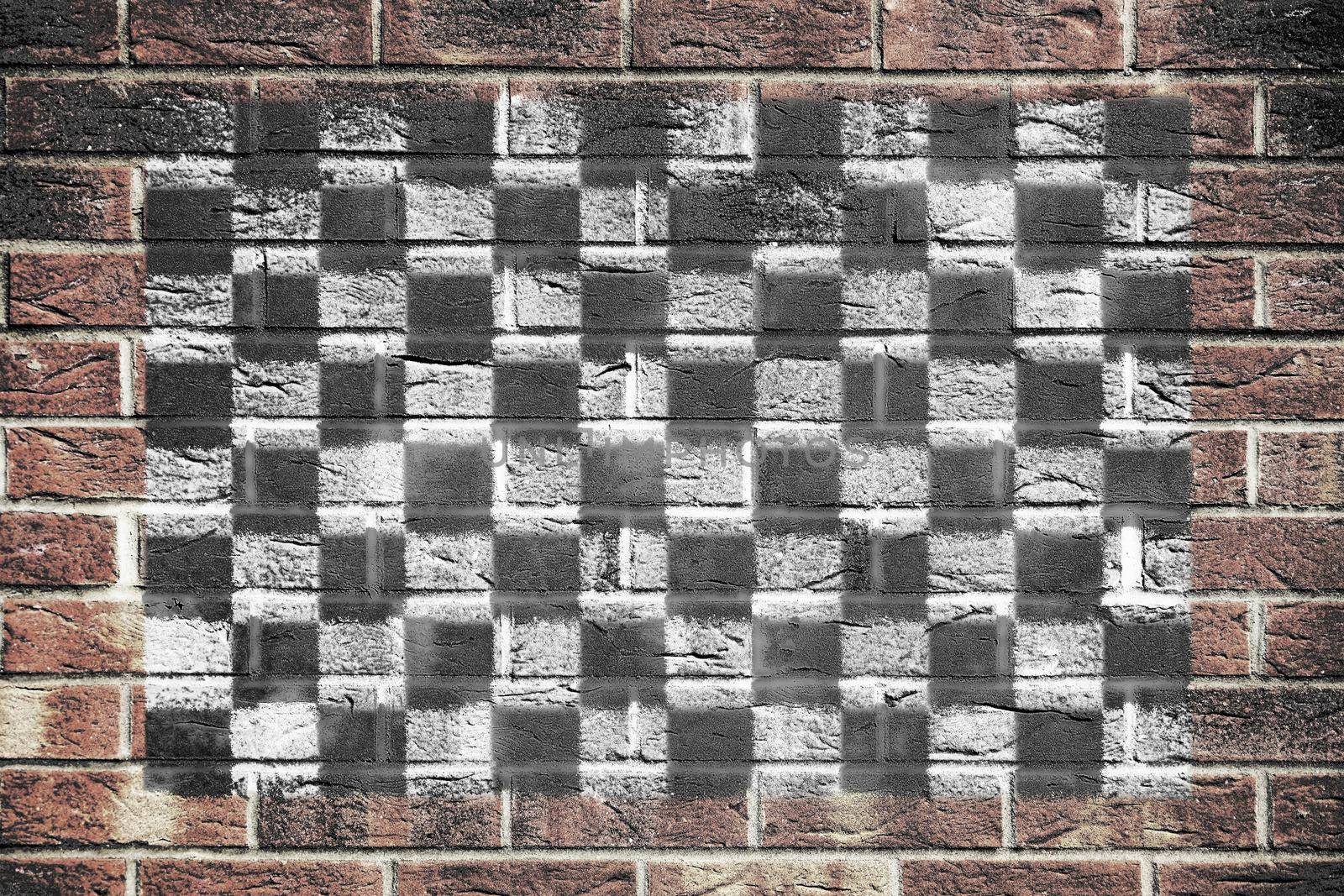 A motor racing chequered flag on brick wall background