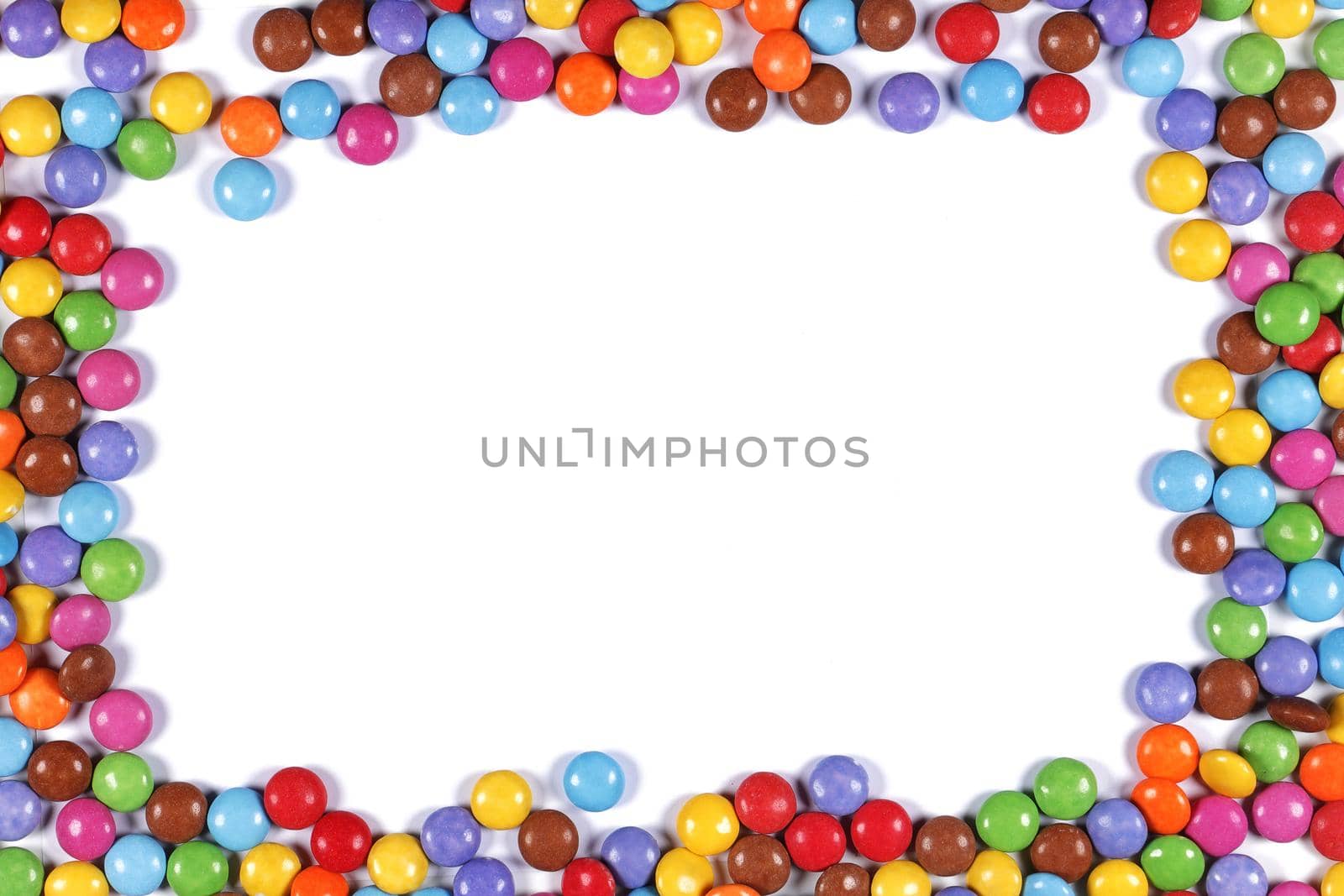 A multi coloured halloween candy sweet border on white