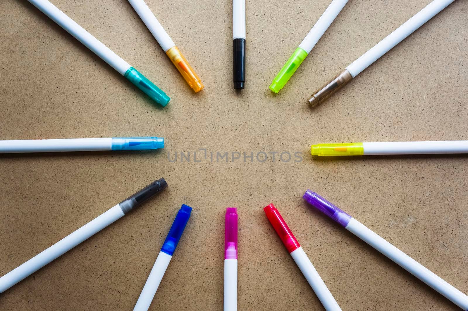 Back to school. Free space. The markers are laid in a circle to form a place for the inscription. Children's creativity crayons on a kraft background by mr-tigga