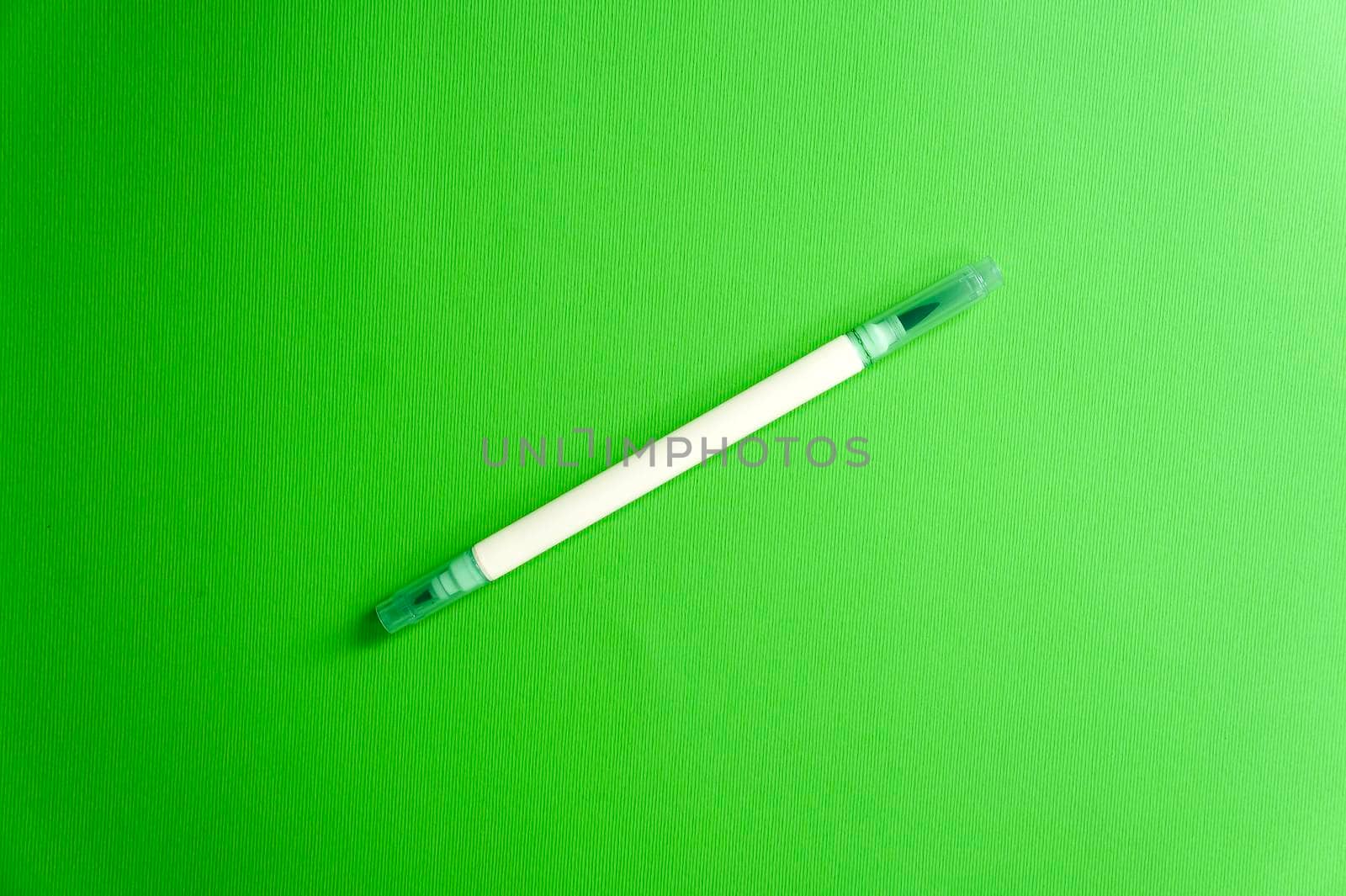 Emerald green marker on a green background, a fresh mood. Back to school. Double sided art marker. Color mood