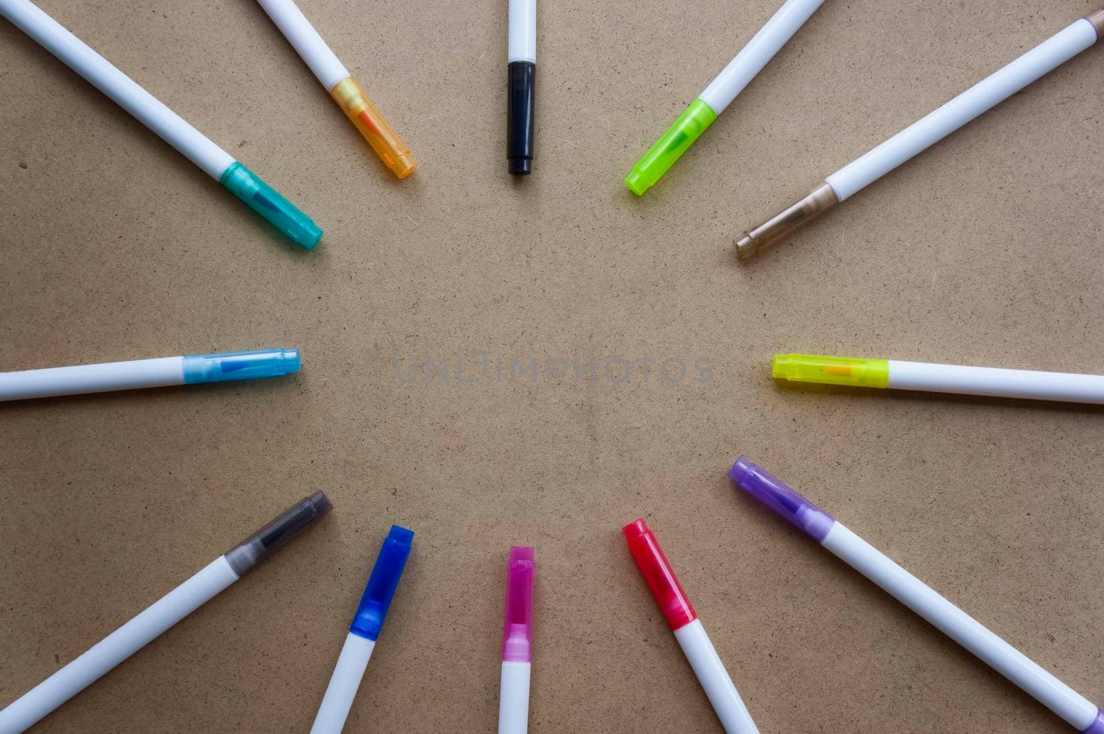 Back to school. Free space. The markers are laid in a circle to form a place for the inscription. Children's creativity crayons on a kraft background by mr-tigga