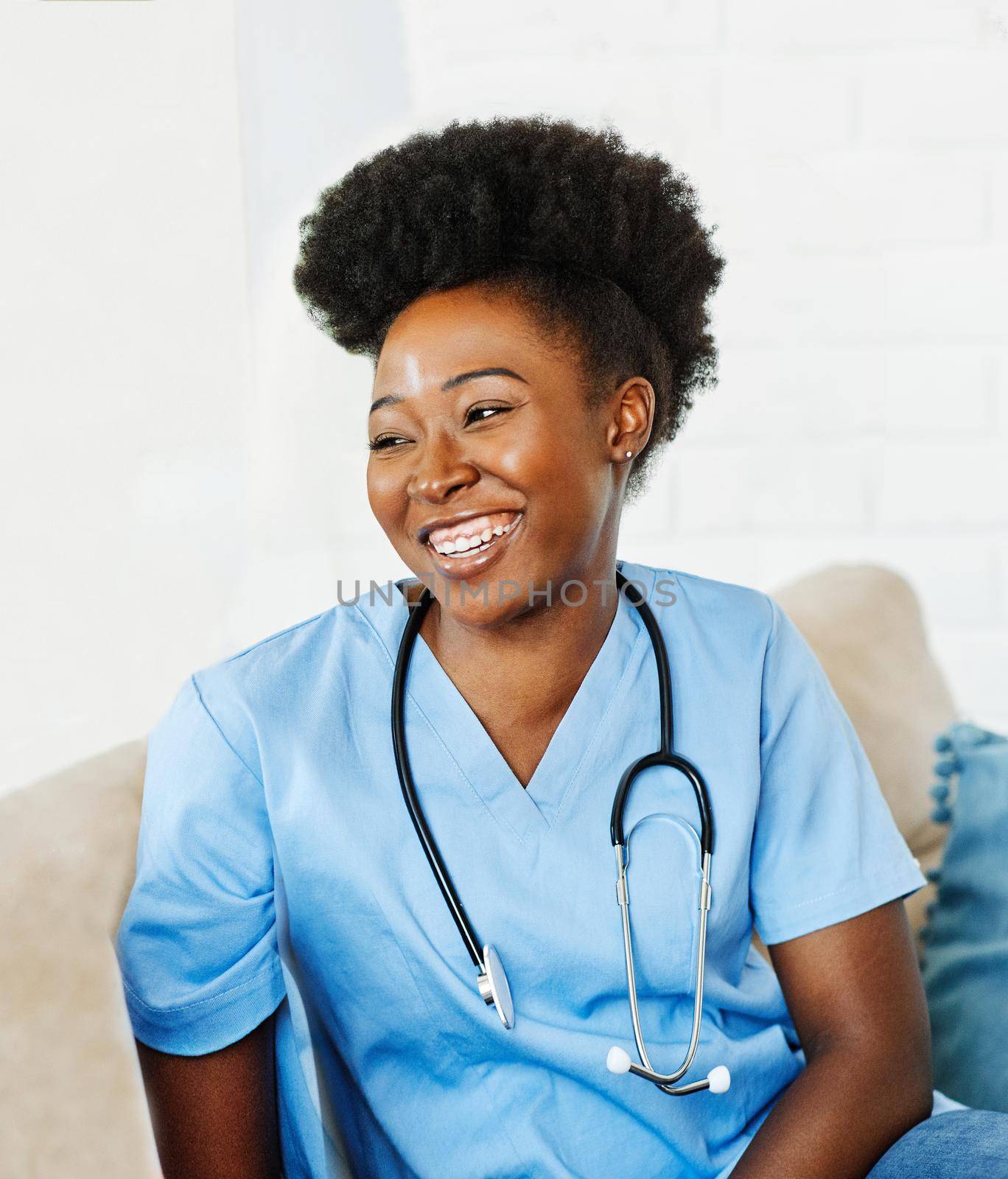 Portrait of a young female nurse caregiver in a nursing home or visit in household