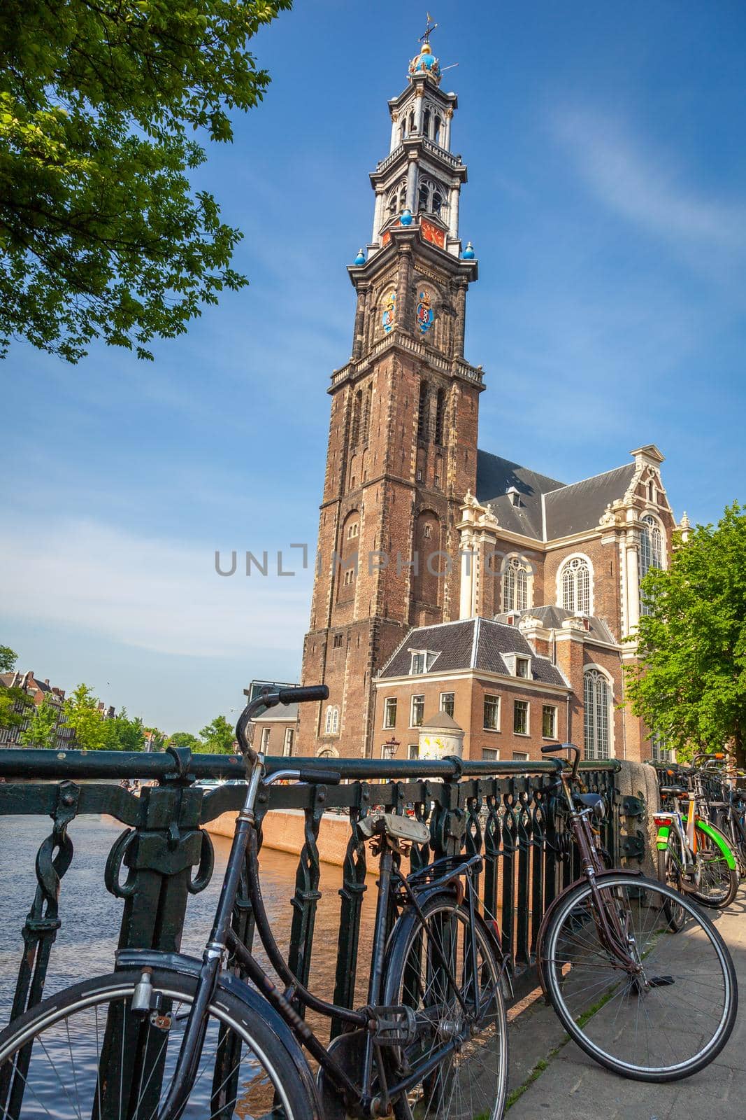 Amsterdam canal with bicycles and dutch architecture at sunrise, Netherlands