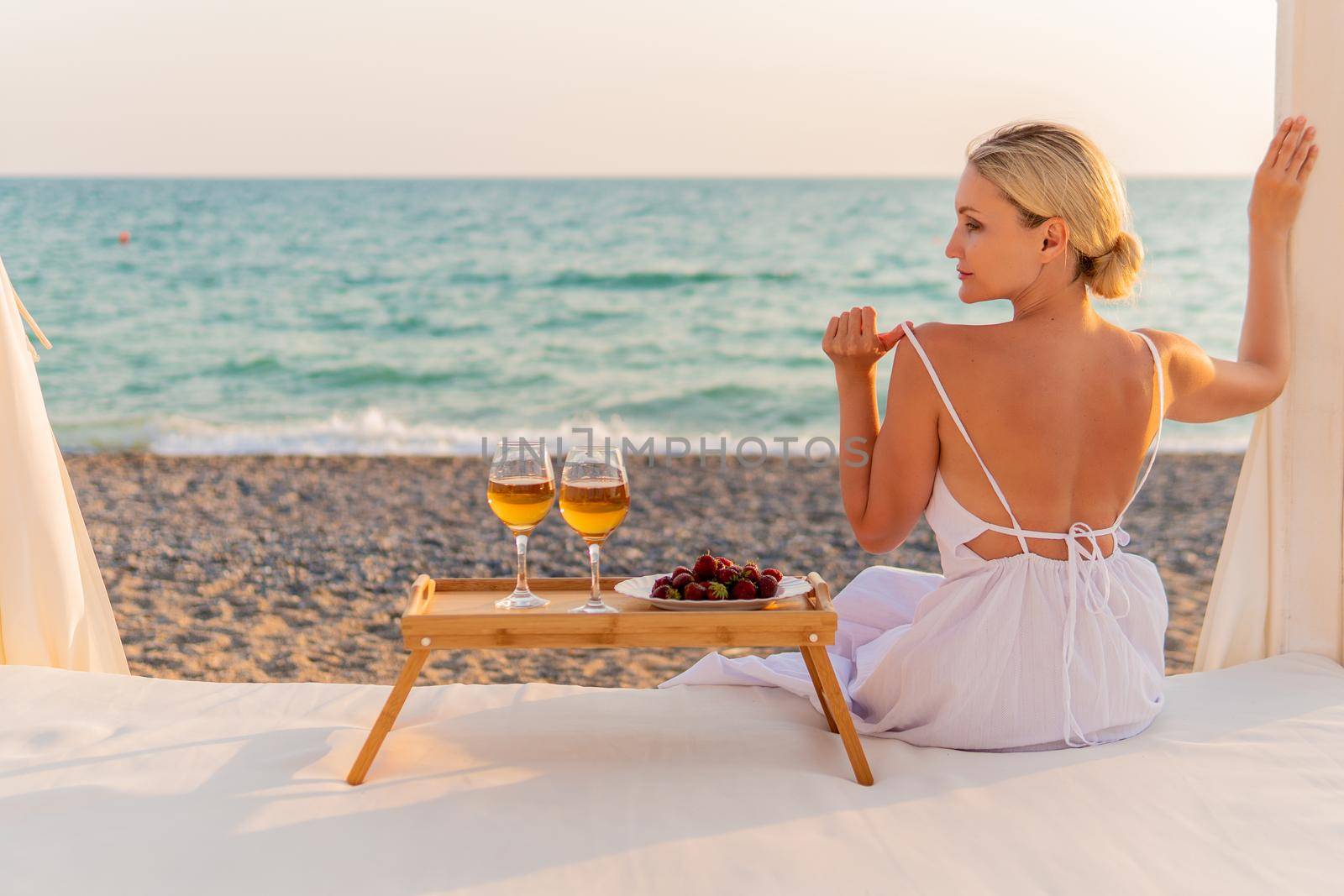 Girl wine restaurant sea rest tray two copyspace beach cold, for provence background in vacation from landscape water, sky food. Coast sunset table,