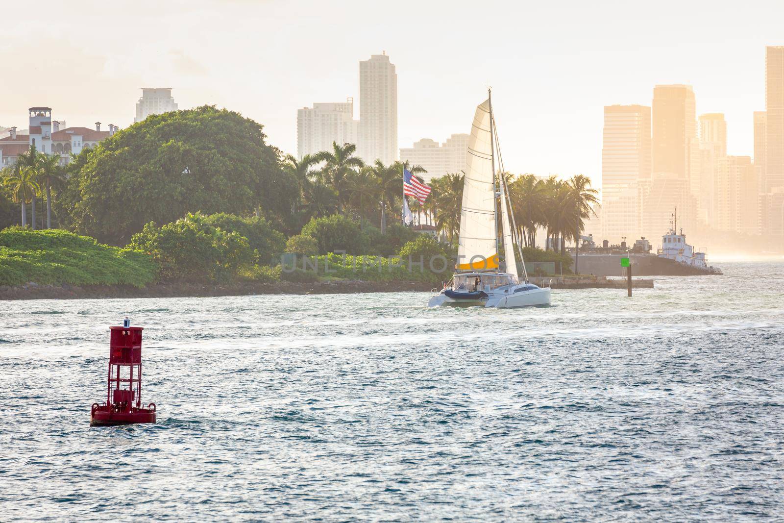 Miami sea habor at golden sunset with american flag, Florida, United States