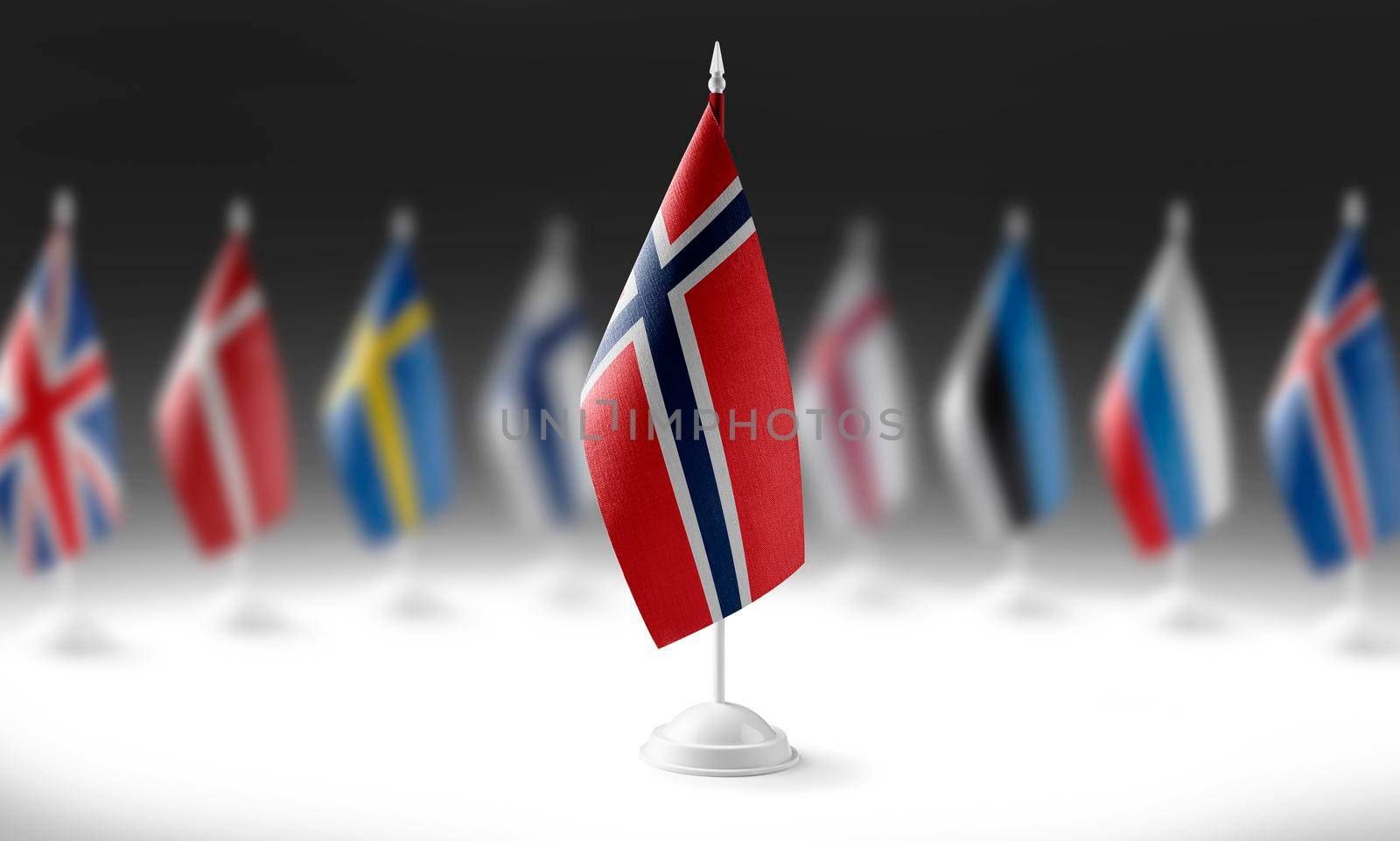 The national flag of the Norway on the background of flags of other countries.