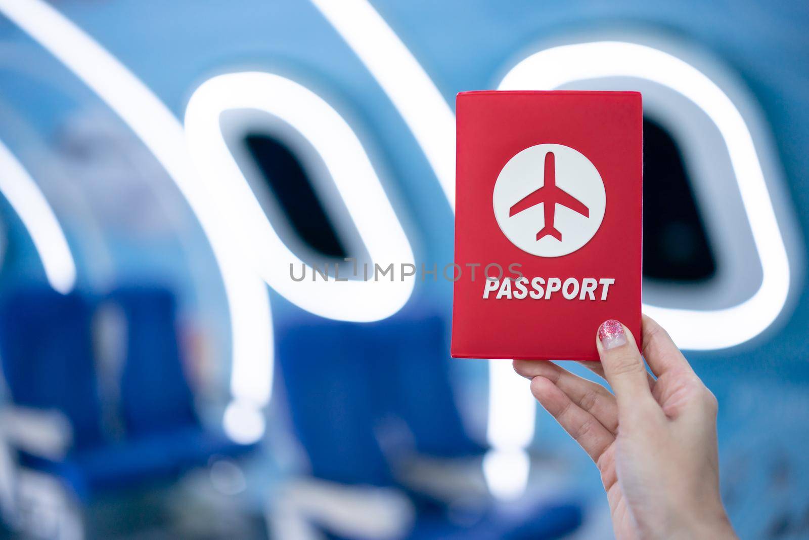 Woman hand showing passport inside airplane.