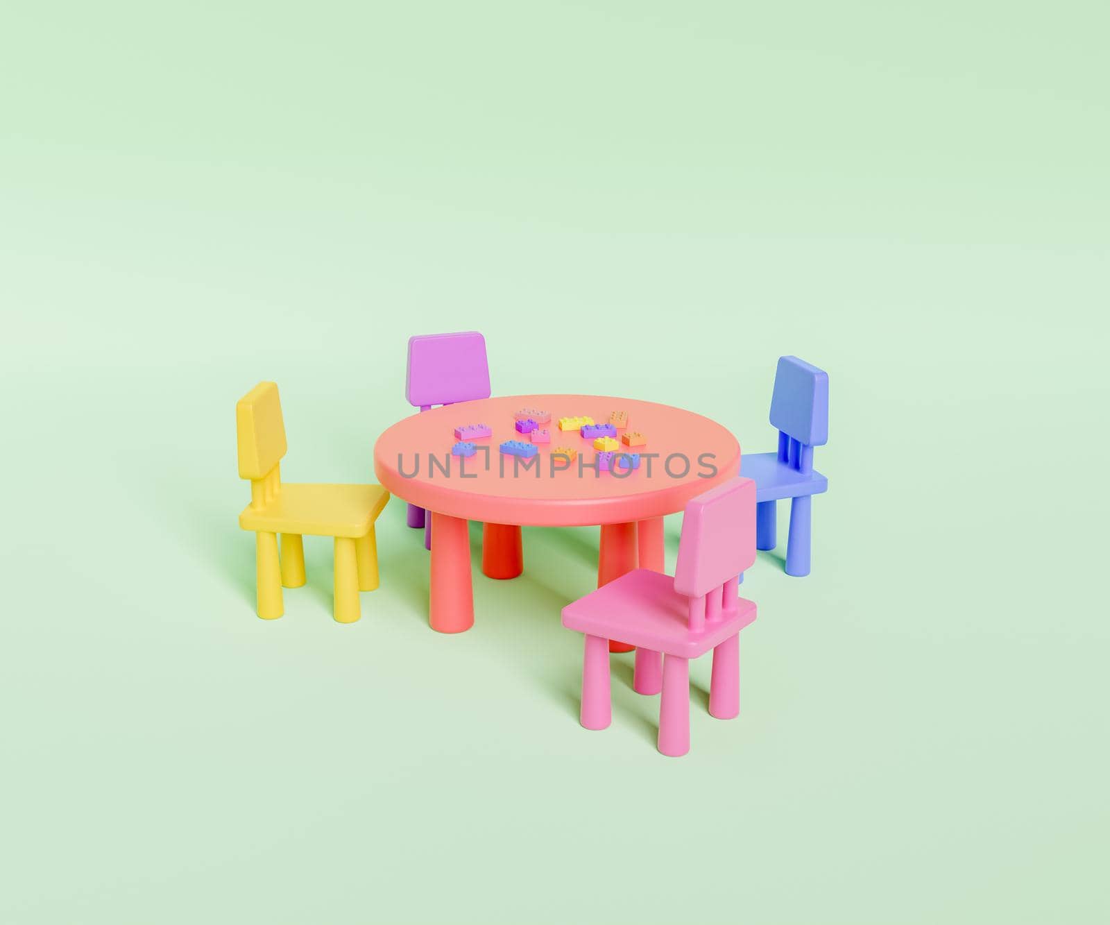 Colorful chairs placed at round table with scattered plastic blocks by asolano
