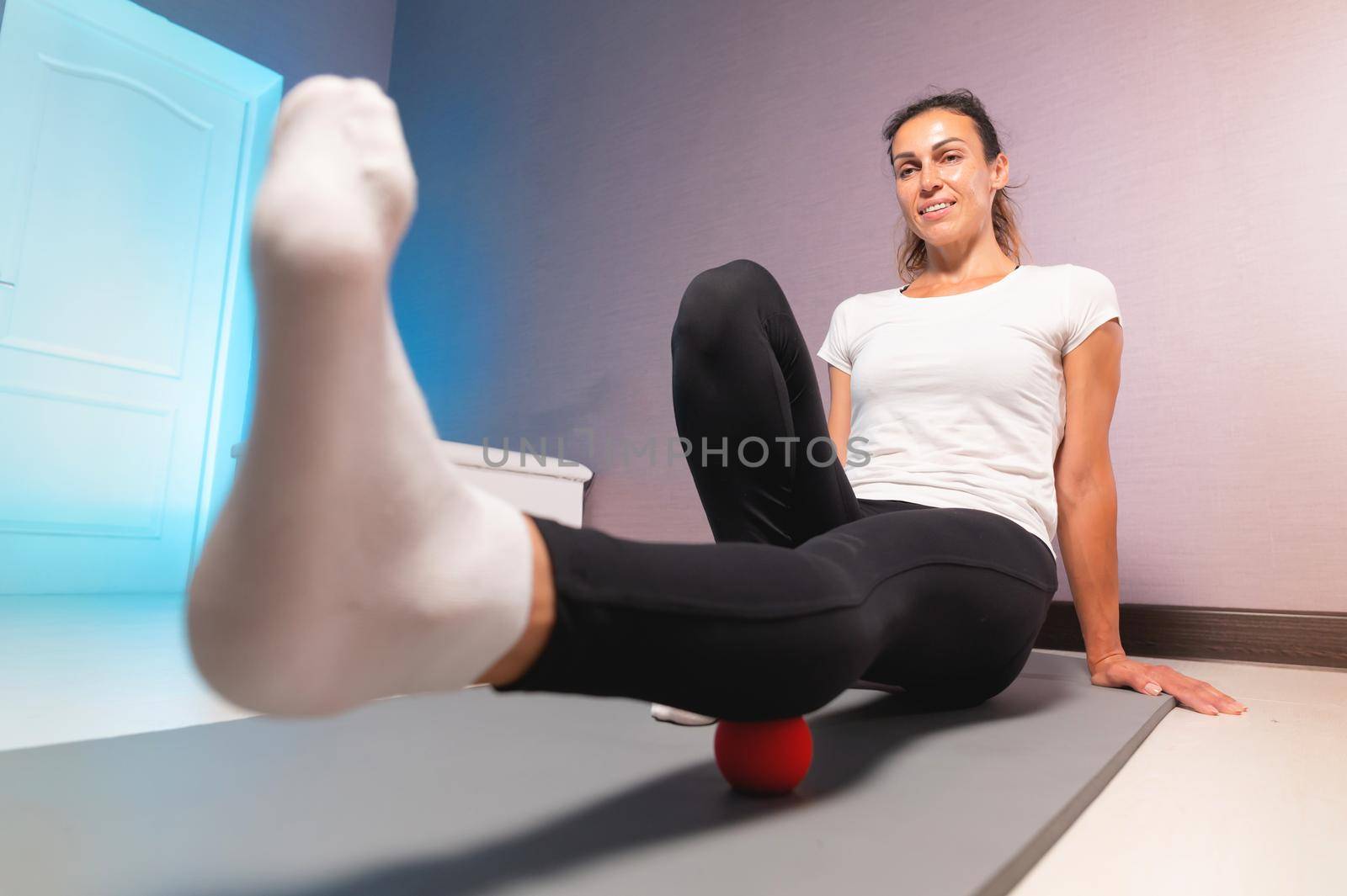 Young attractive woman doing exercises, wide angle view from below, indoor workout at home.