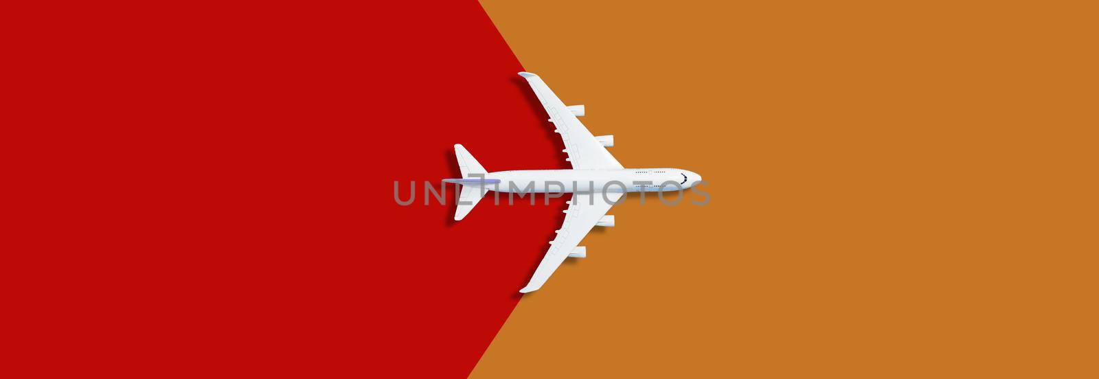 Model plane,airplane on pastel color background orange red. High quality photo
