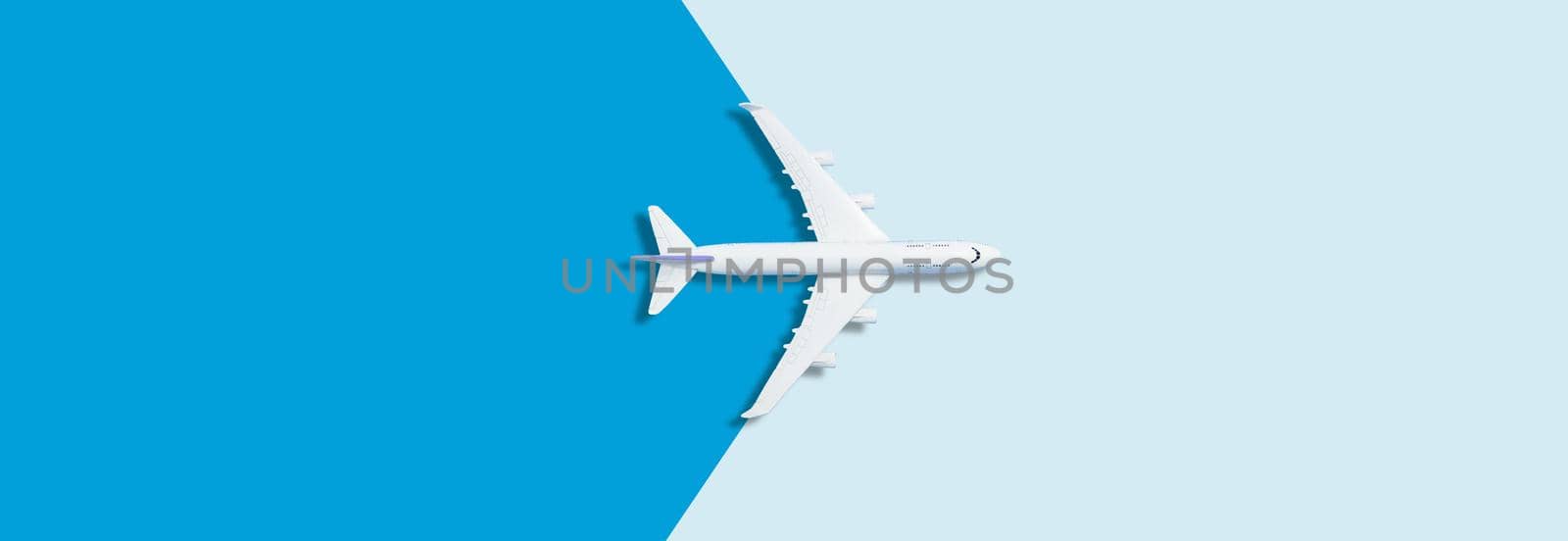 Flat lay design of travel concept with plane on blue background with copy space by Andelov13