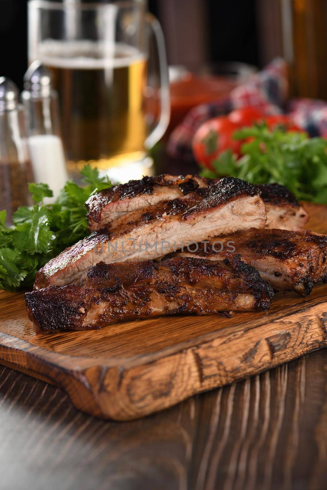 Delicious Baked Grilled Sliced pork belly with barbeque  sauce plating on wooden plate,  herbs and vegetables