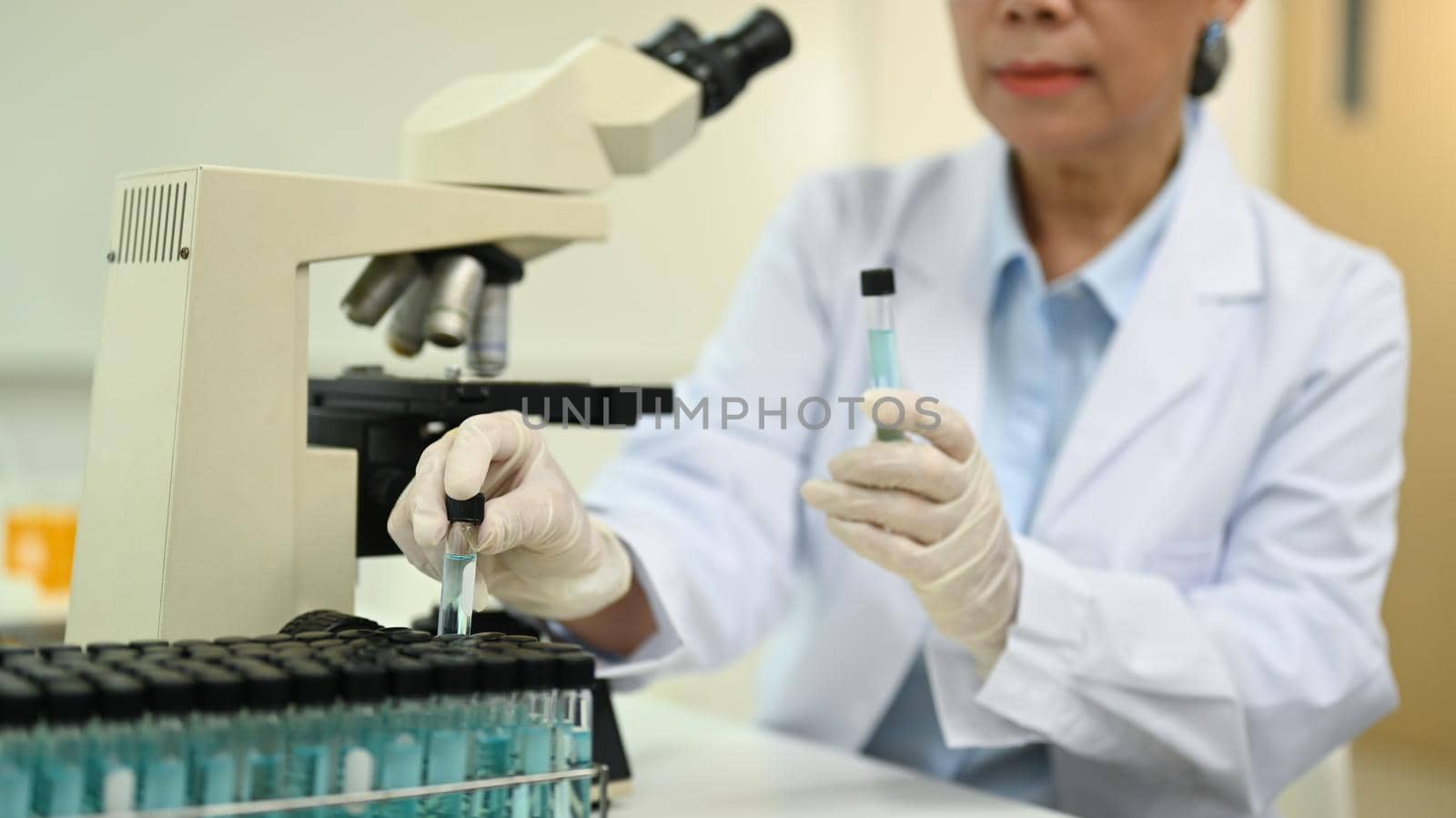 Researchers scientist working with blue liquid test tube in the laboratory. Medicine and science researching concept.