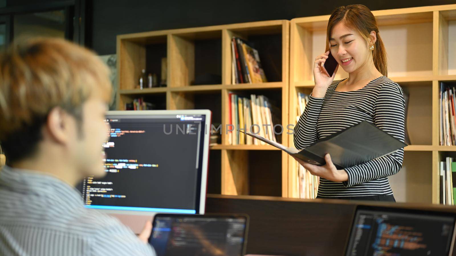 Young developers or coder team working together on software design project at modern office.