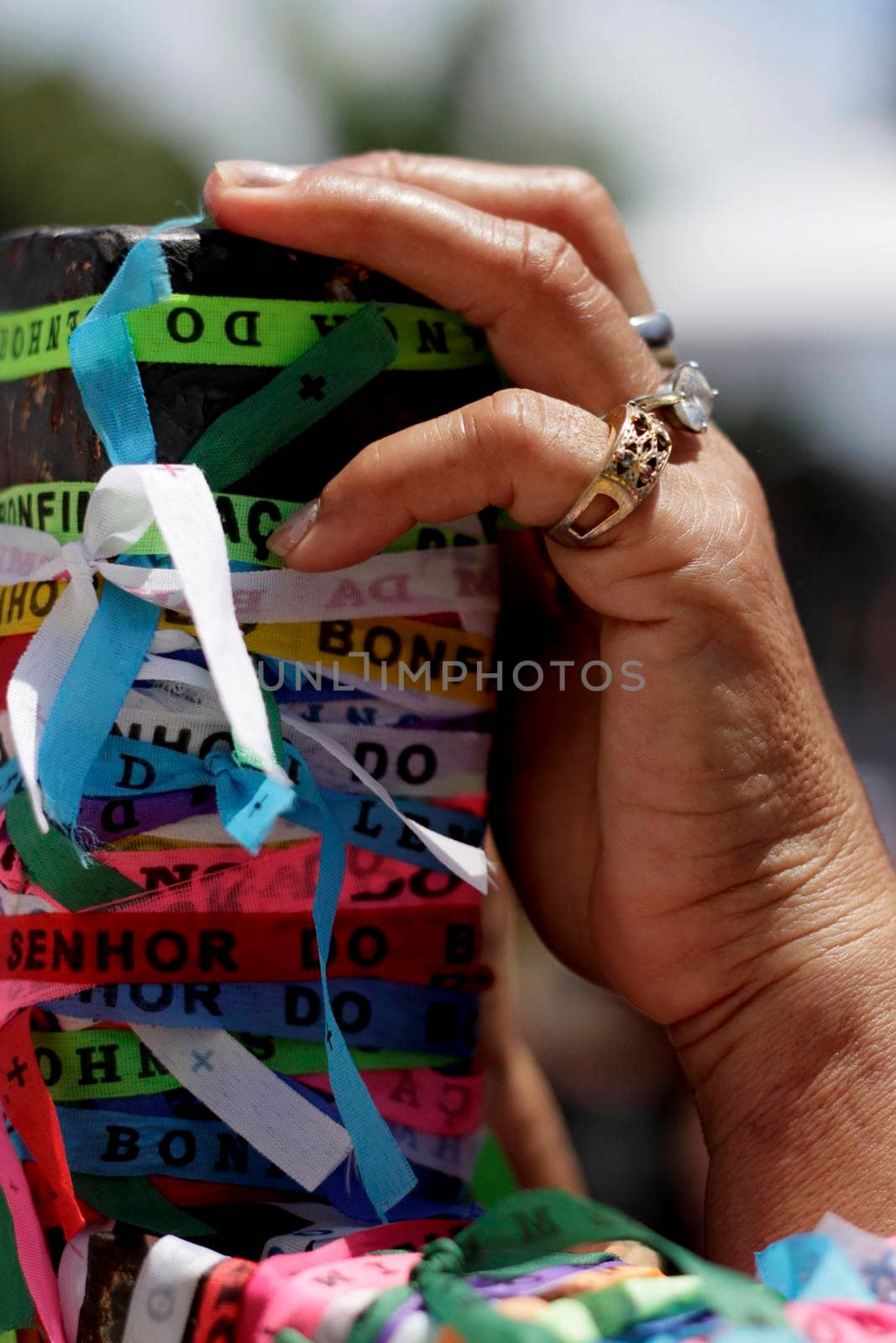 salvador, bahia / brazil - january 15, 2015: hand holds Senhor do Bonfim ribbon during traditional washing of Bonfim church stairs in the city of Salvador.