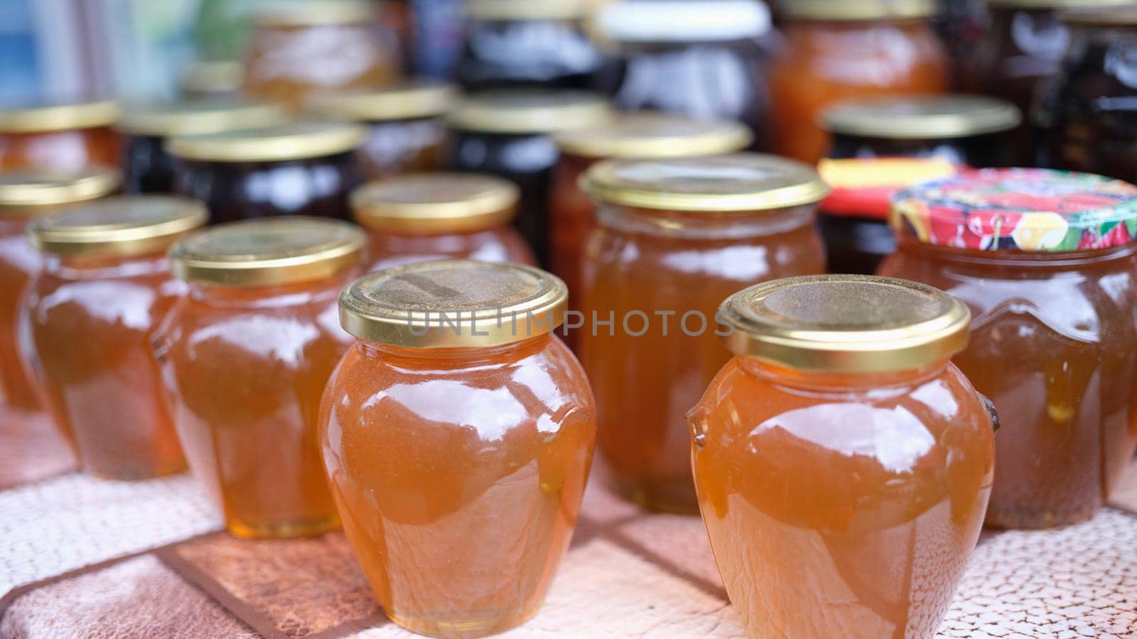 Lot of homemade apple juice in jars closeup. Homemade seams in jars concept