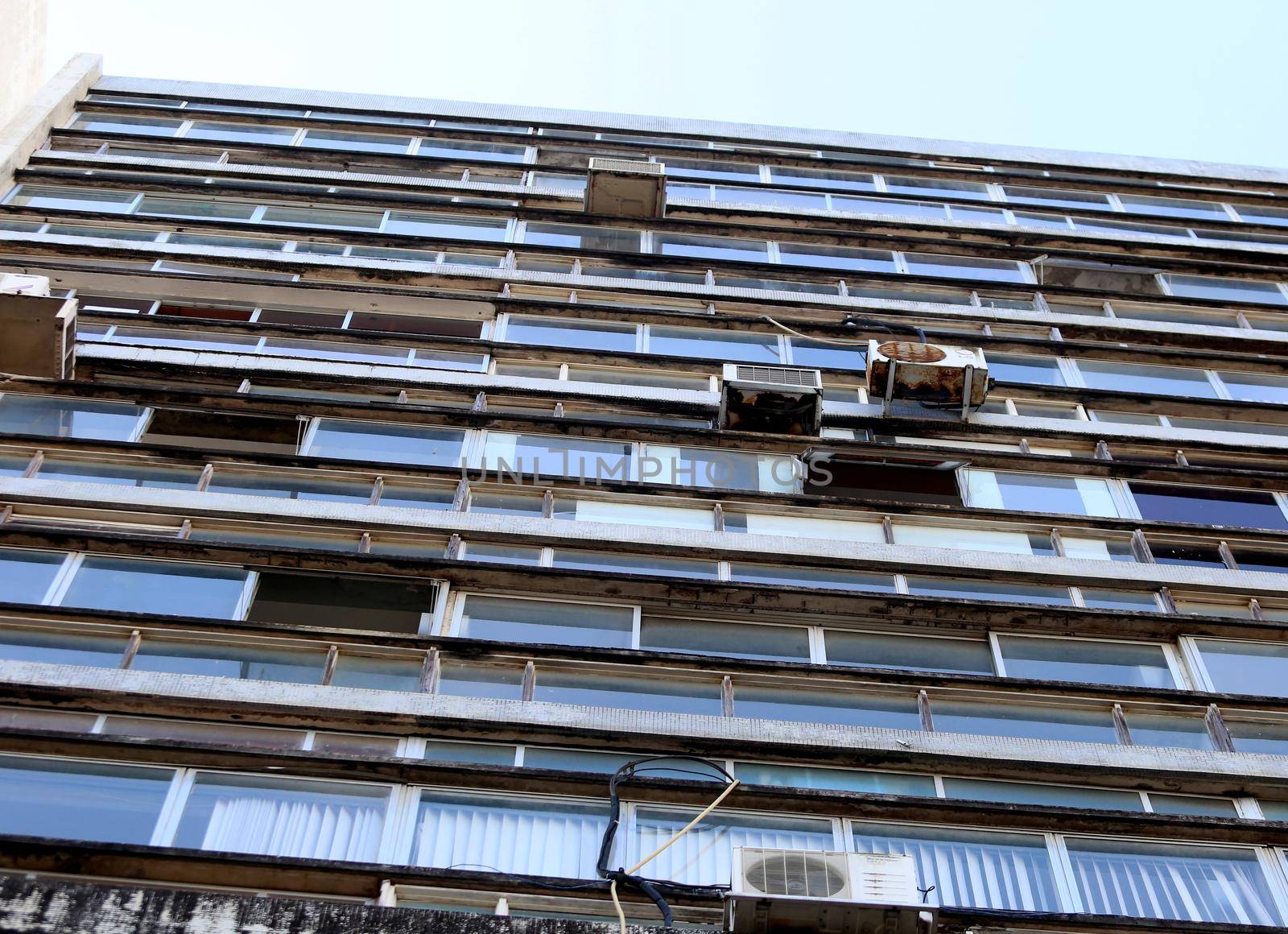 salvador, bahia / brazil - august 13, 2018: air conditioner with rusty brackets and risk of falling are seen installed in a commercial building on Ruy Barbosa Street in downtown Salvador.