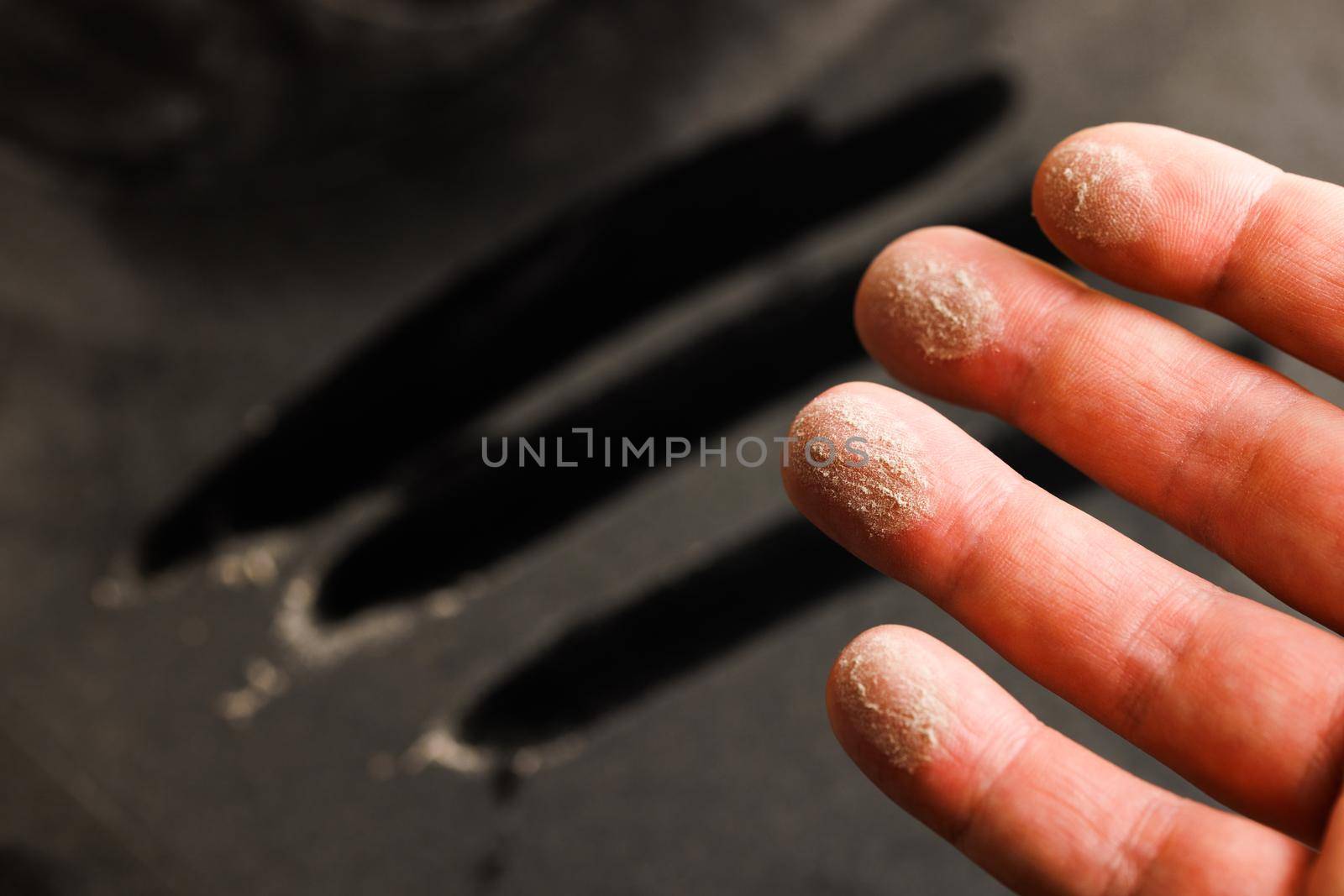 caucasian hand with dust on finger tips after touching black dusty surface by z1b