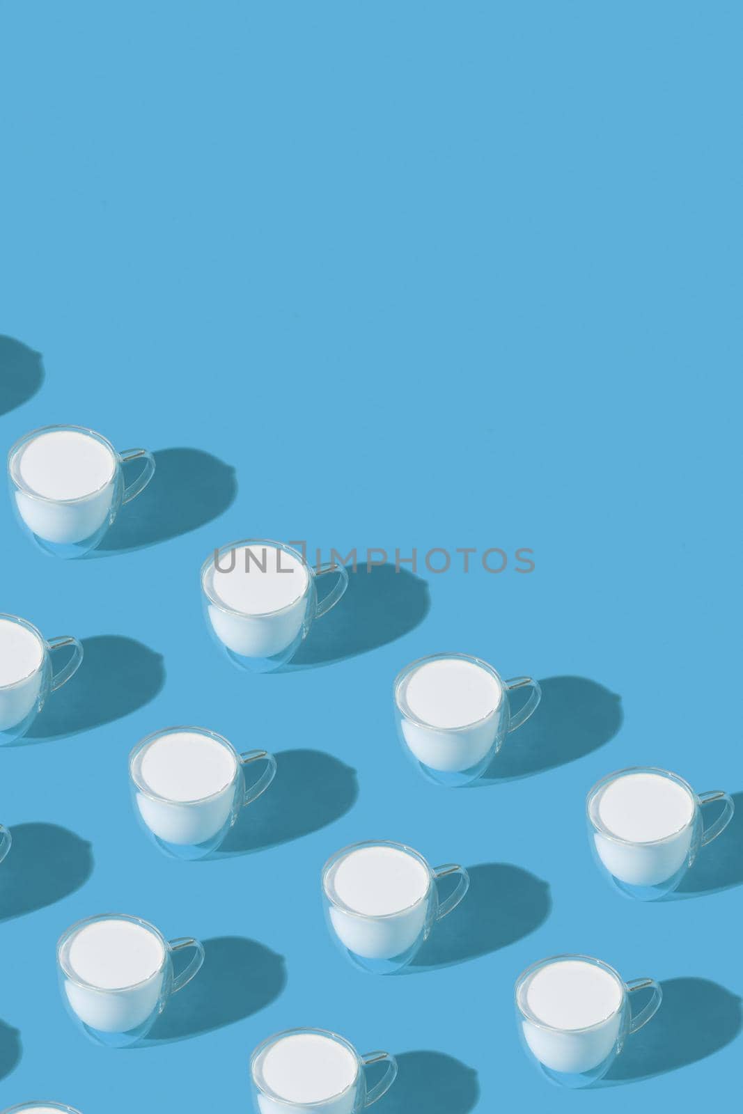 Milk in a glass pattern on a colored background, dairy diet concept. High quality photo