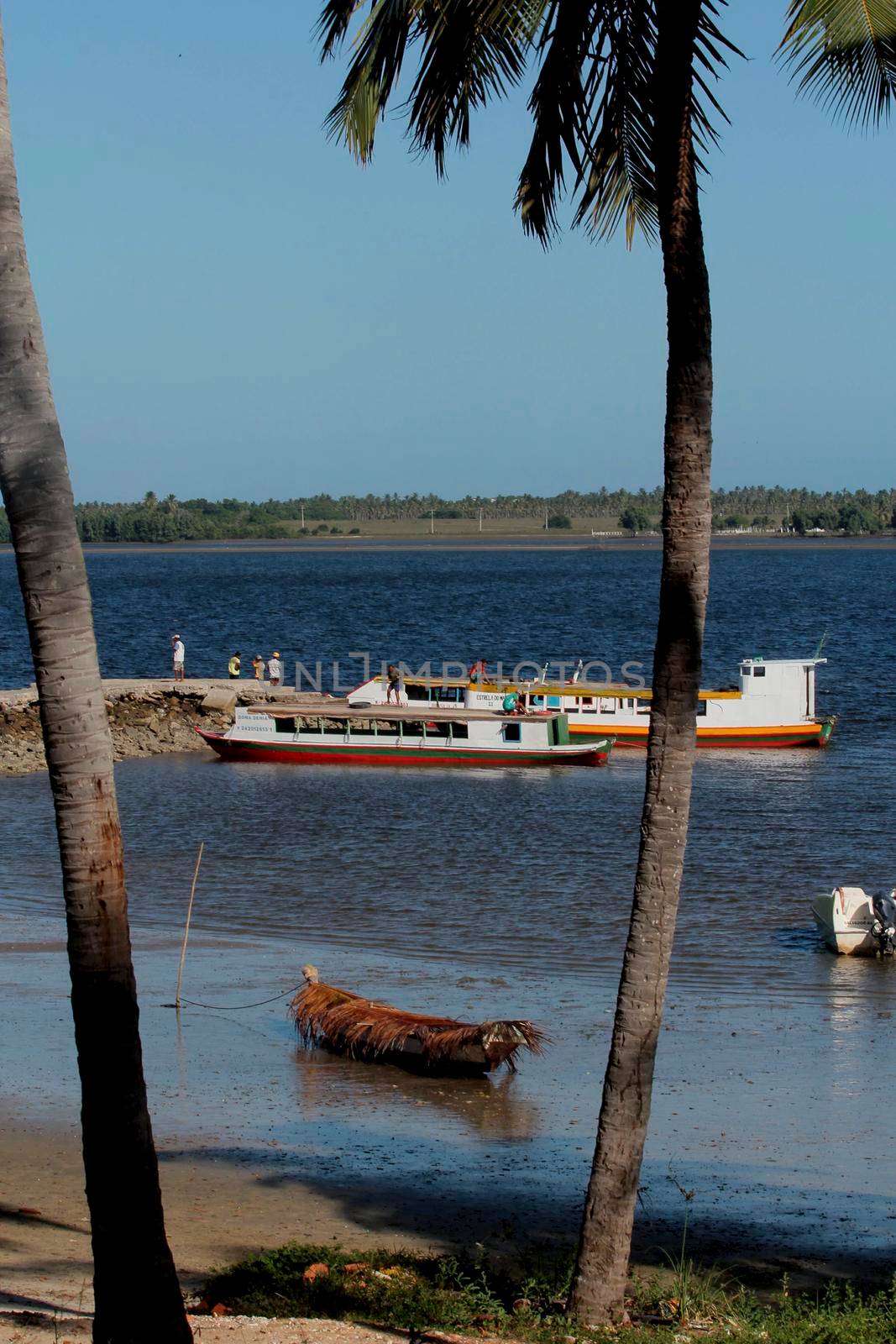 jandaira, bahia / brazil - december 24, 2013: boat is seen near the port of Mangue Seco, fishing village and tourist spot in the city of Jandaira.
