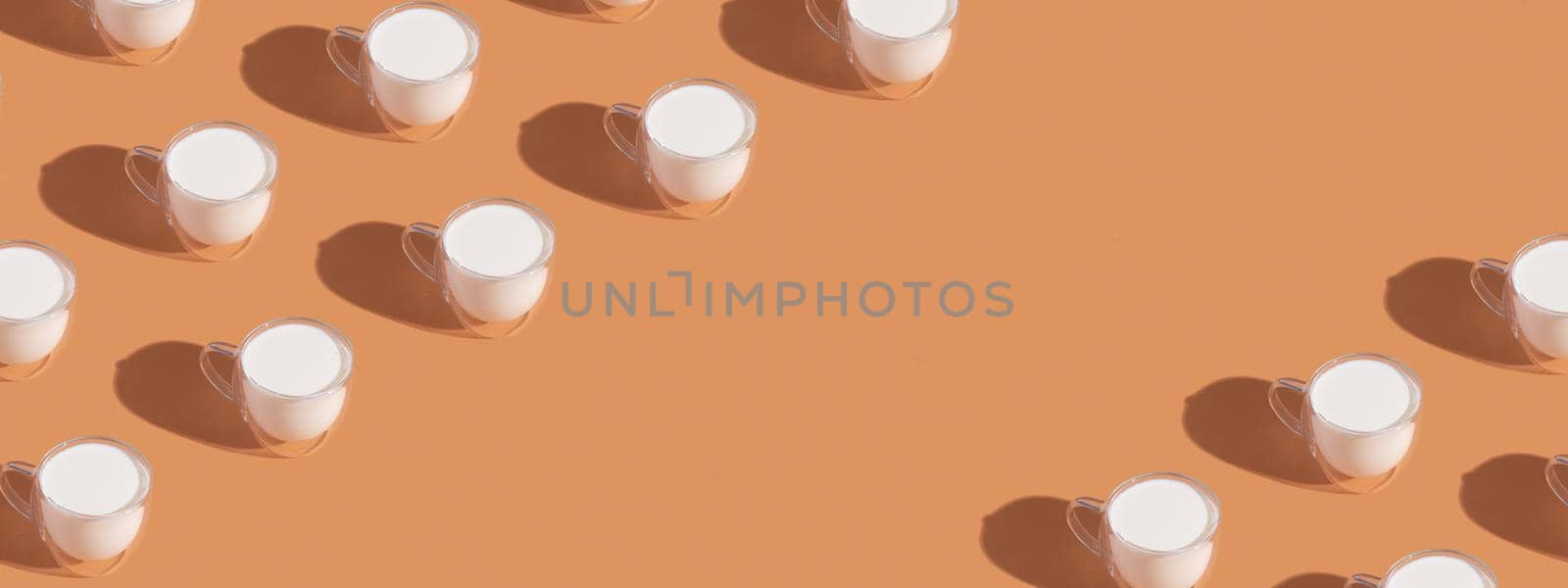 Banner with milk in a glass pattern on a colored background, dairy diet concept . High quality photo