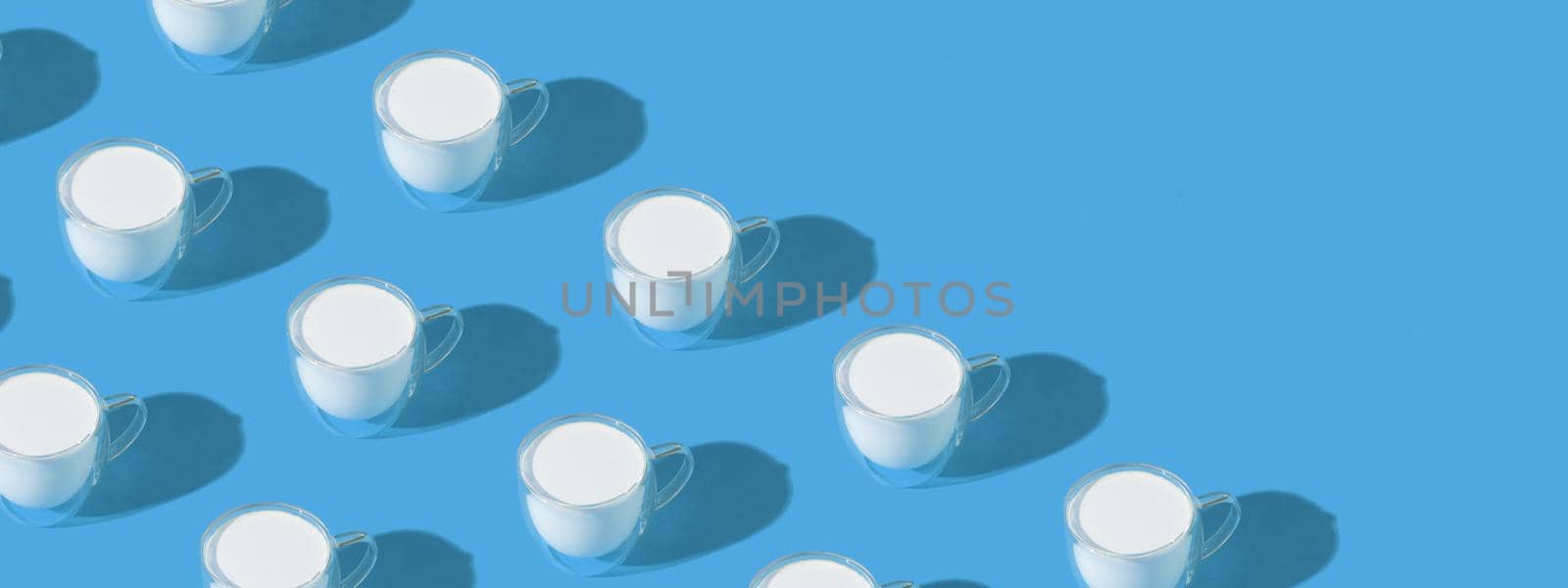 Banner with milk in a glass pattern on a colored background, dairy diet concept . High quality photo