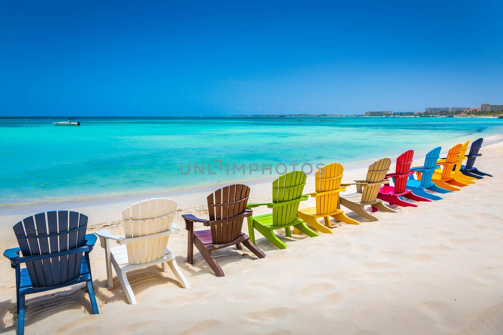 Idyllic beach with rustic adirondack chairs in Aruba, Dutch Antilles by positivetravelart