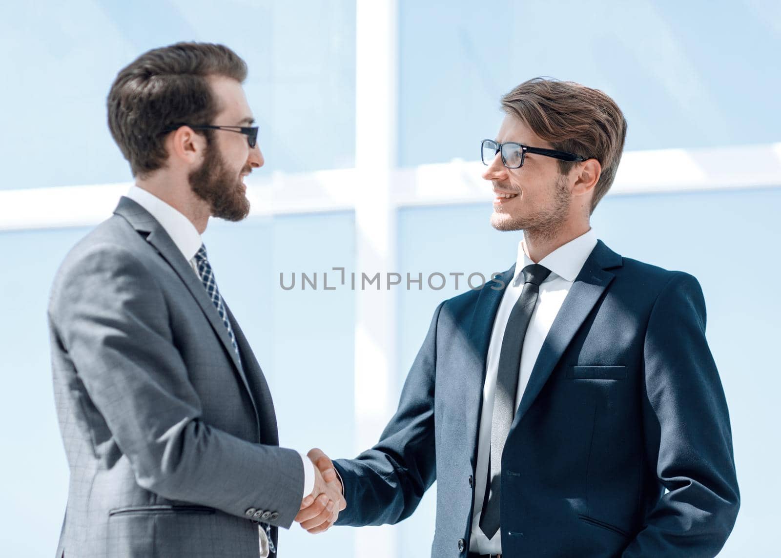 two business people shaking hands by asdf