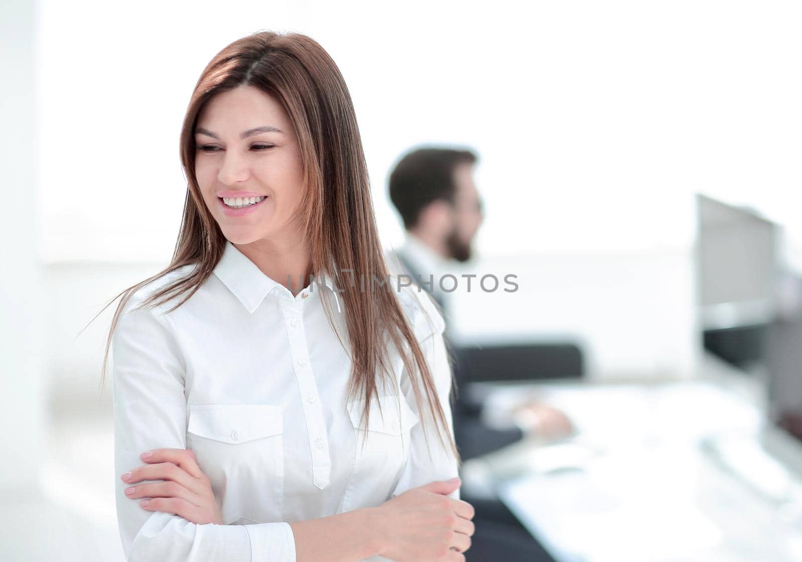 smiling business woman on the background of the workplace. by asdf