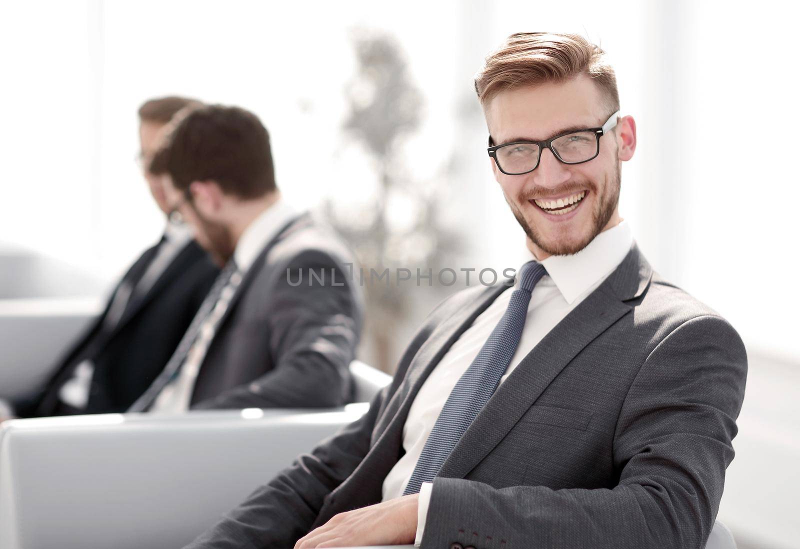 close up.happy businessman sitting in modern office.business people