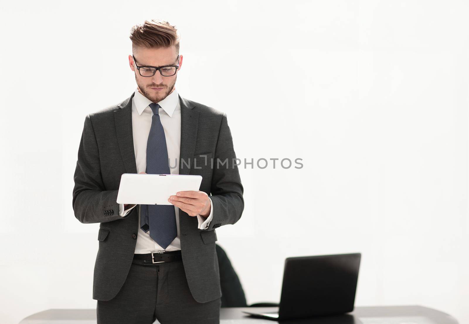 responsible businessman looking at the digital tablet screen by asdf