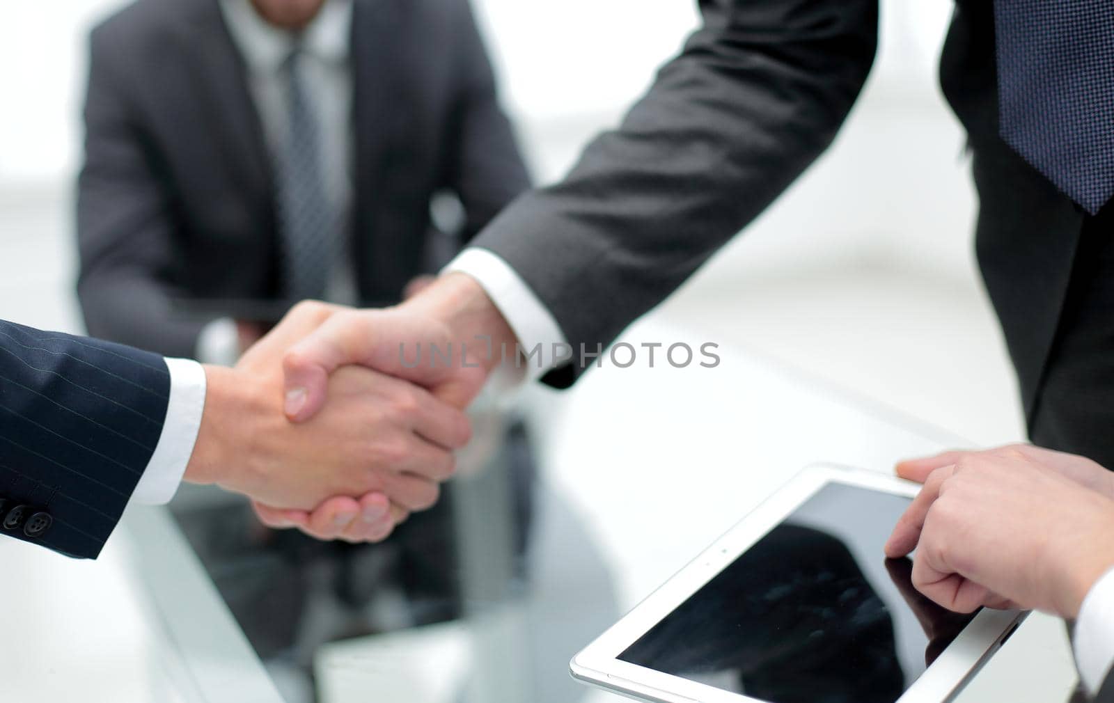 close up.financial partners handshake by asdf