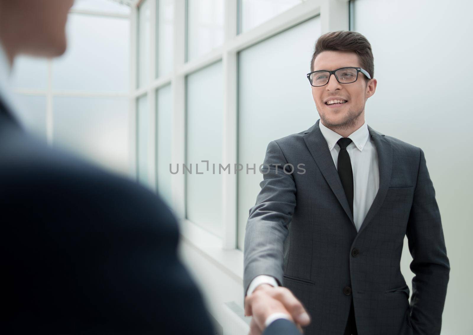 Manager greets the client with a handshake. by asdf