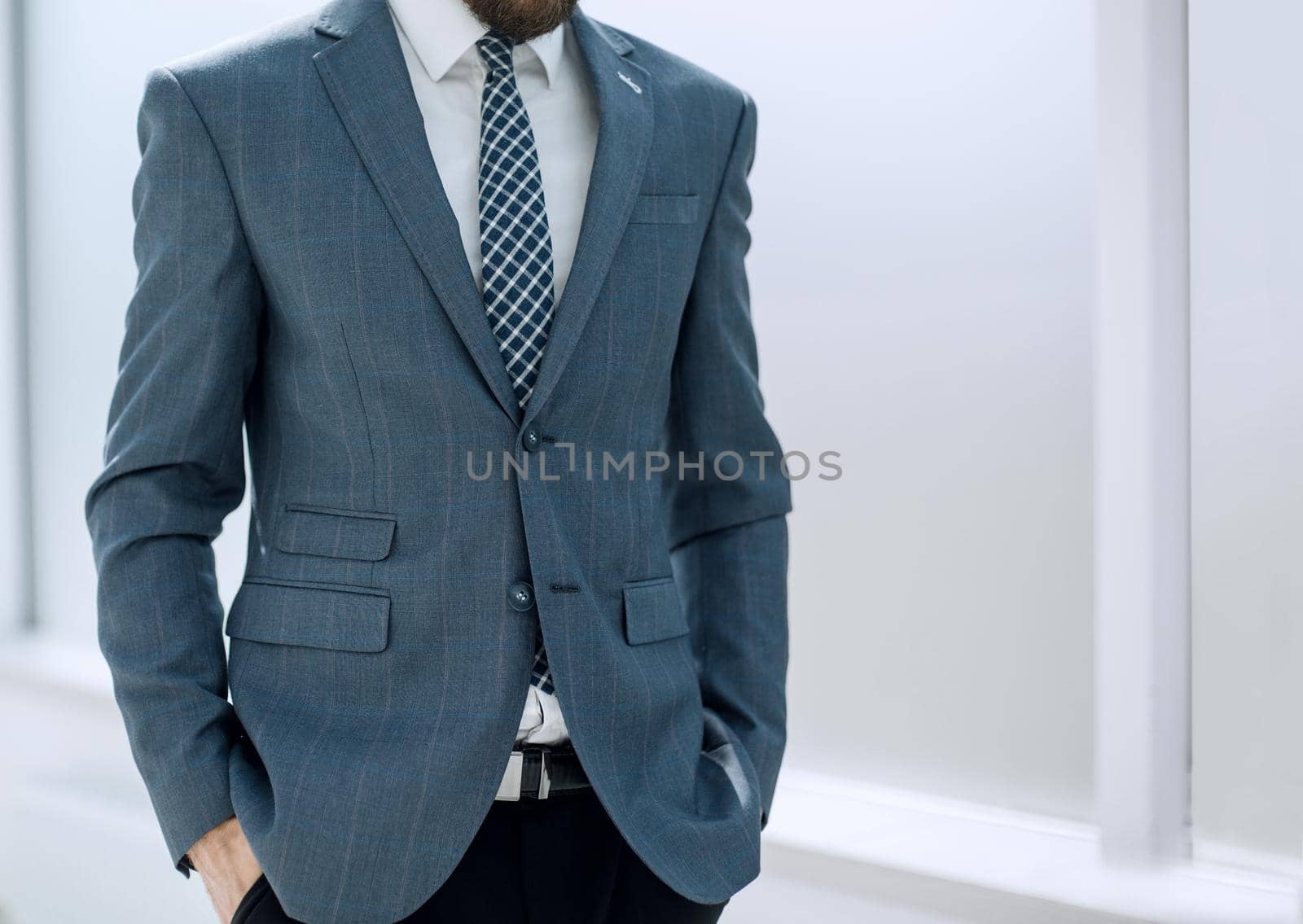 close up.handsome businessman standing in the office.business concept