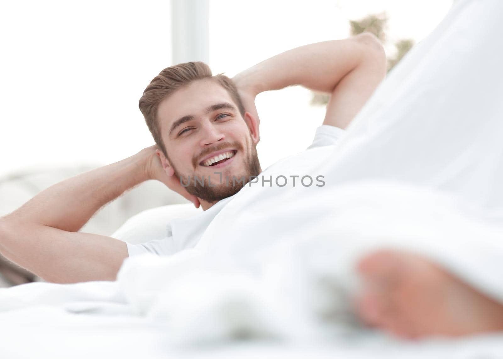closeup.smiling man resting in the bedroom.photo with copy space.