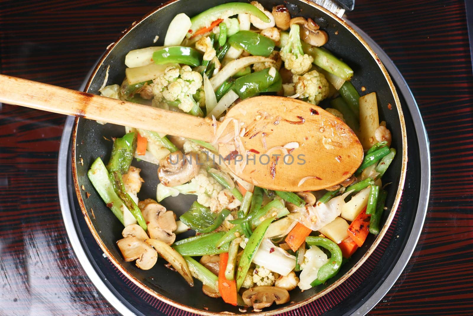 cooking fresh vegetables in a pan, top view ,
