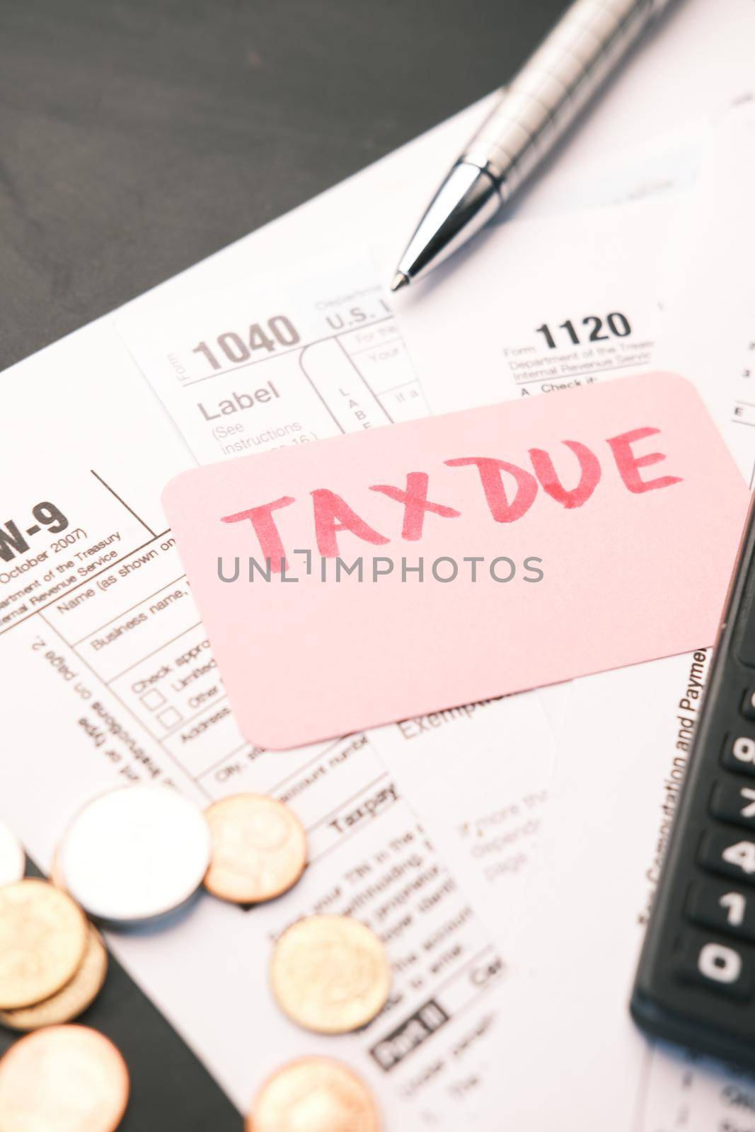 Tax return form and hand written tax due on table .