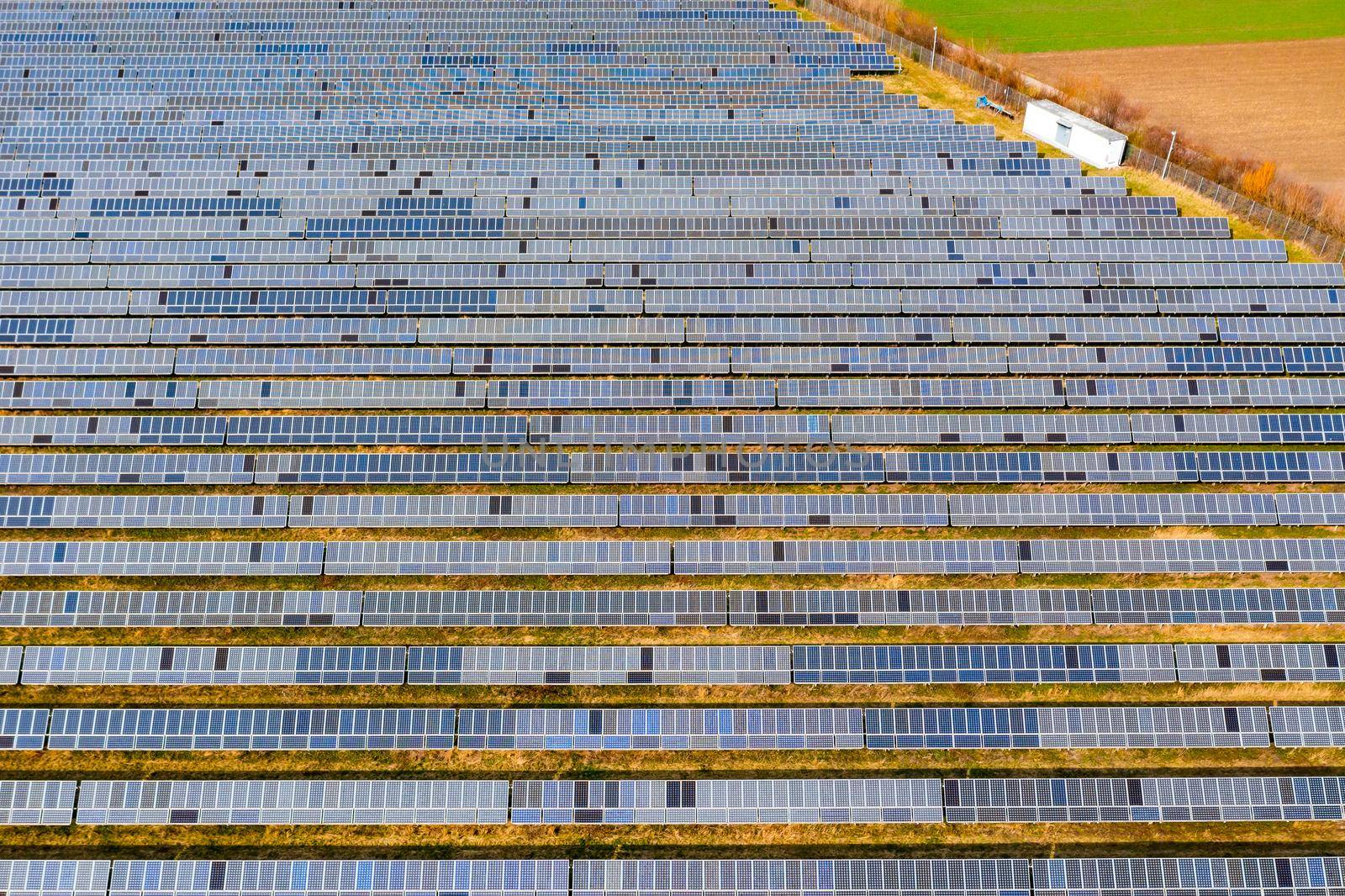 Numerous modules of a photovoltaic system on a solar park in rural Germany