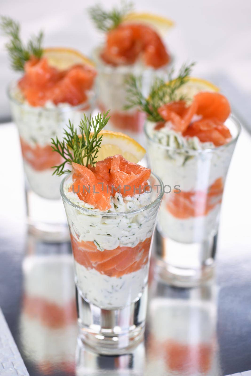 Verrine  from soft cheese cream and salmon, dill sprig and lemon slice. Aperitif appetizer.