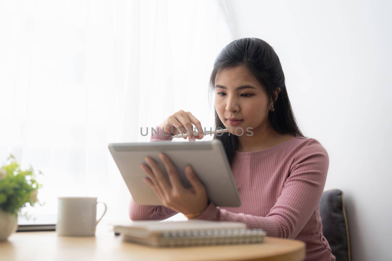 Young asian woman using digital tablet at home. Online learning, home school concept