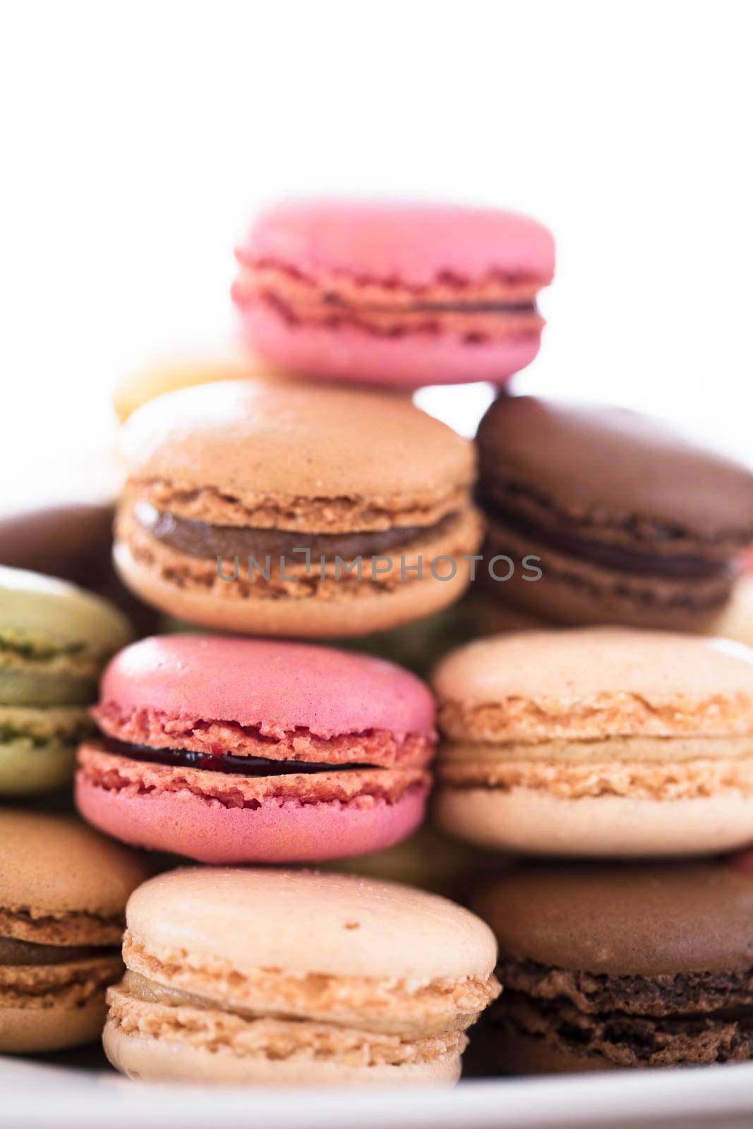 Stack of macaroons, chocolate, vanilla and strawberry