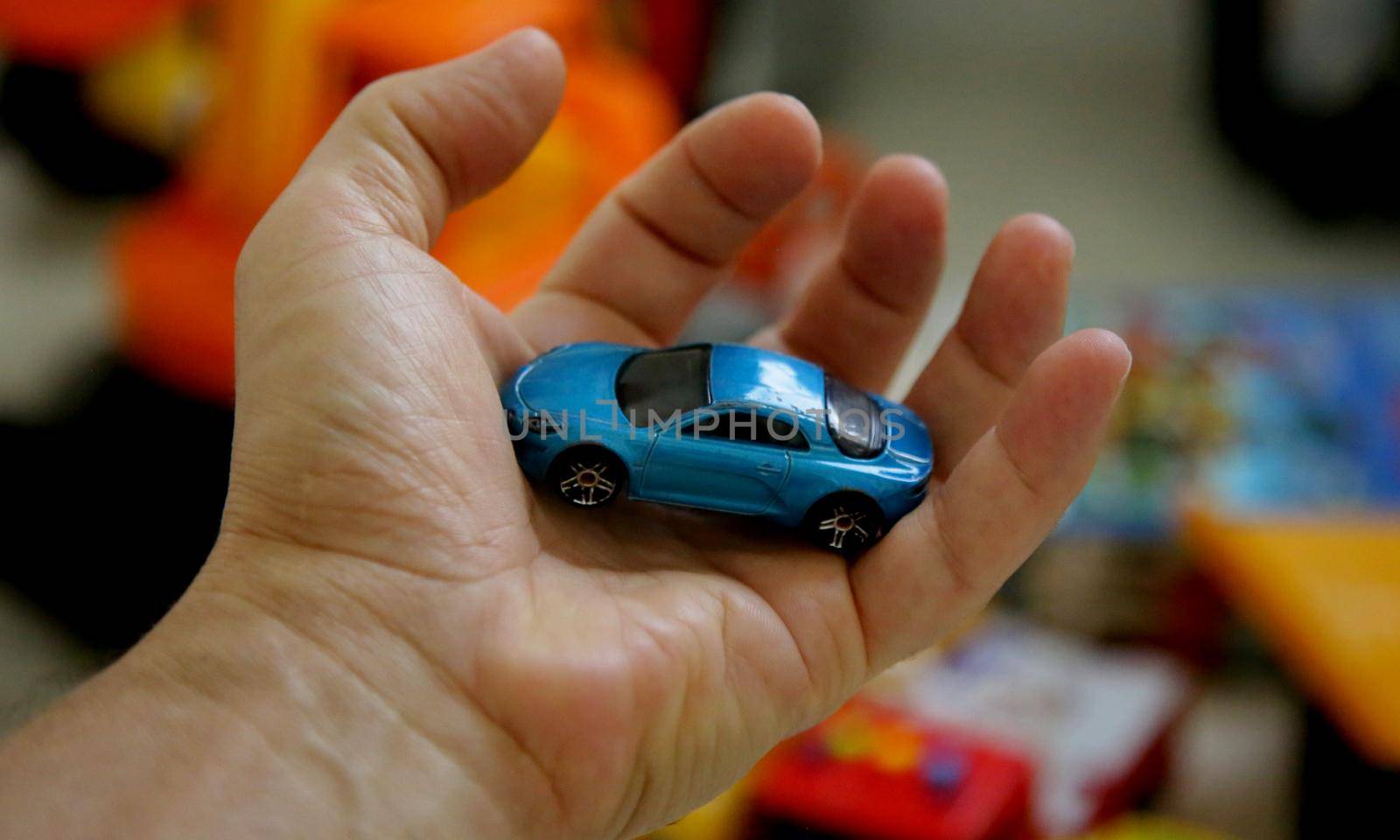 salvador, bahia brazil - may 26, 2020: hand holds replica of a miniature car.


