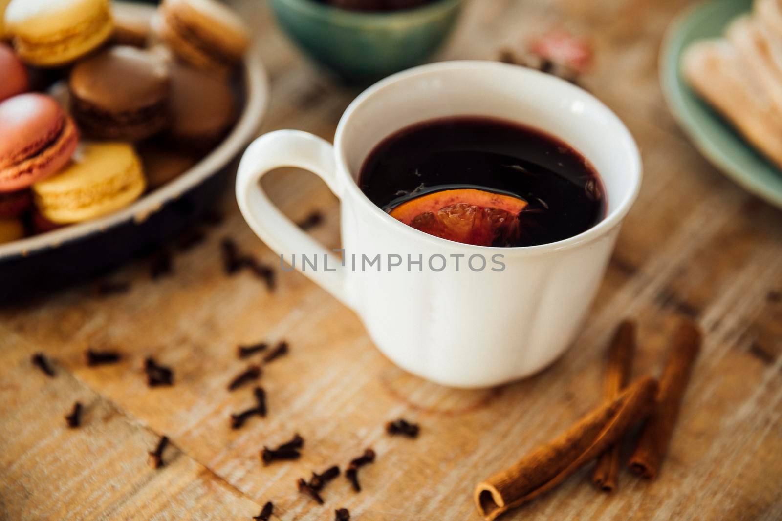 Mug of delicious hot mulled wine with orange wedge.