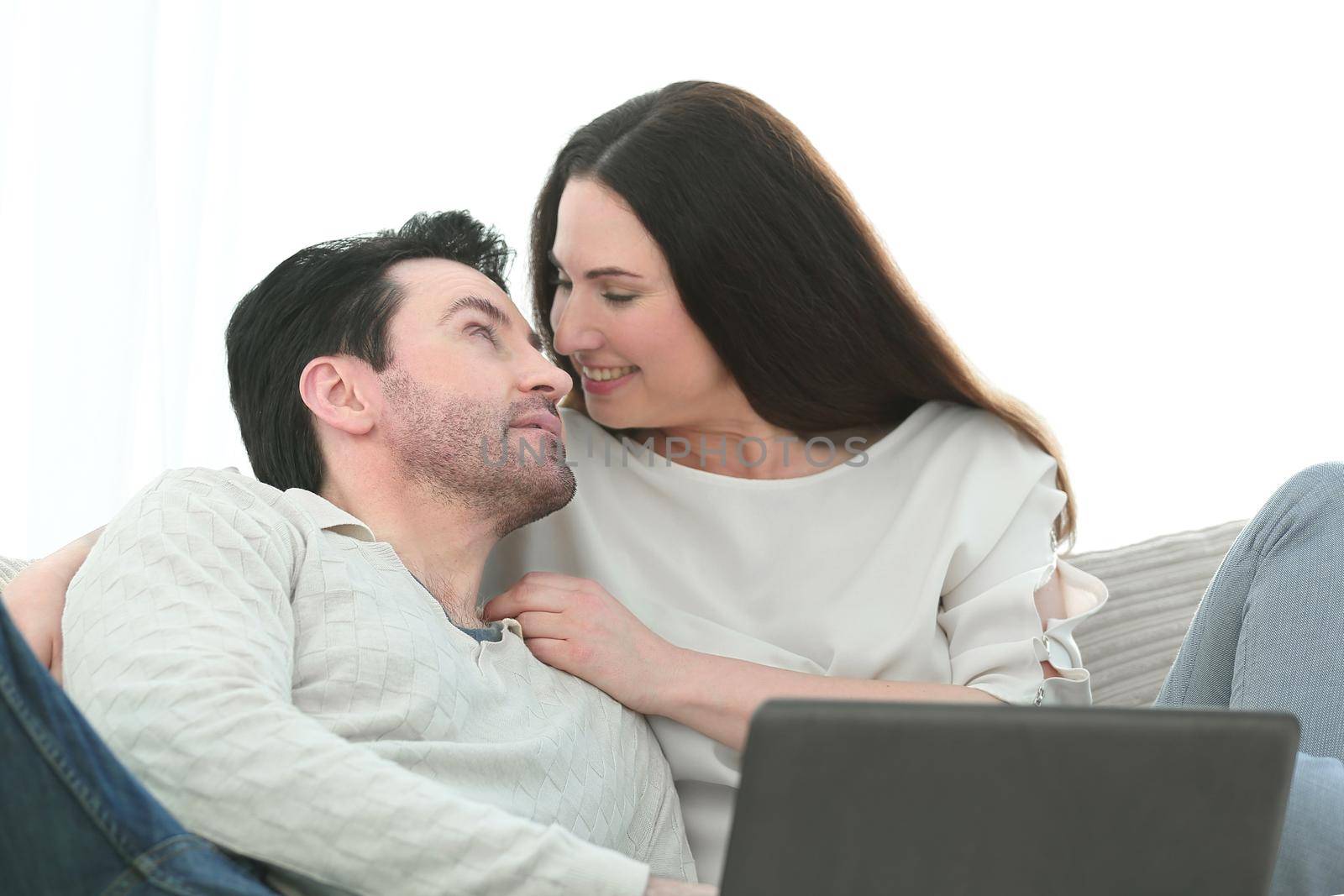 man with his girlfriend chatting on laptop at home indoor by asdf
